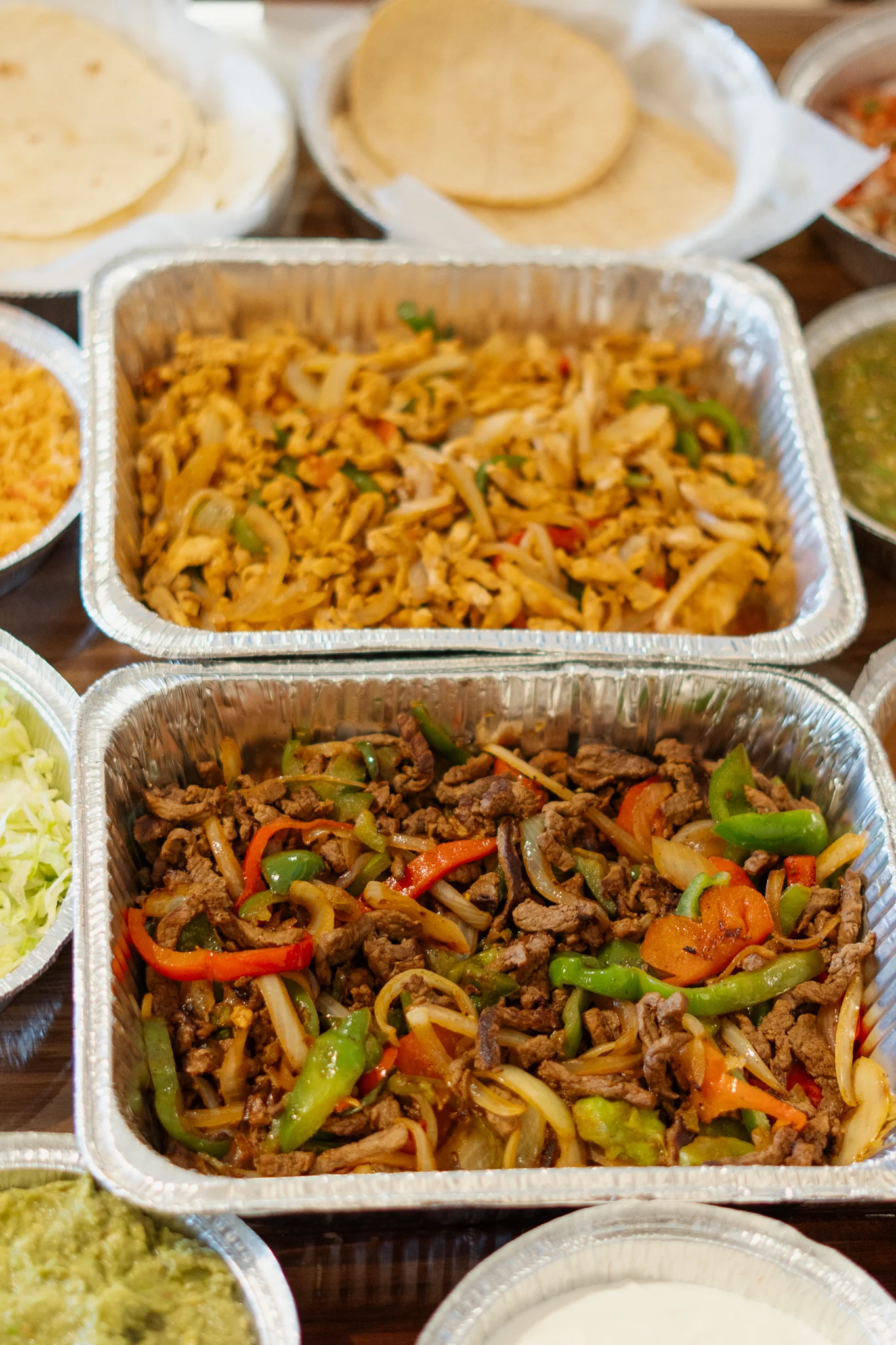 Sizzling fajitas served with tortillas and fresh toppings