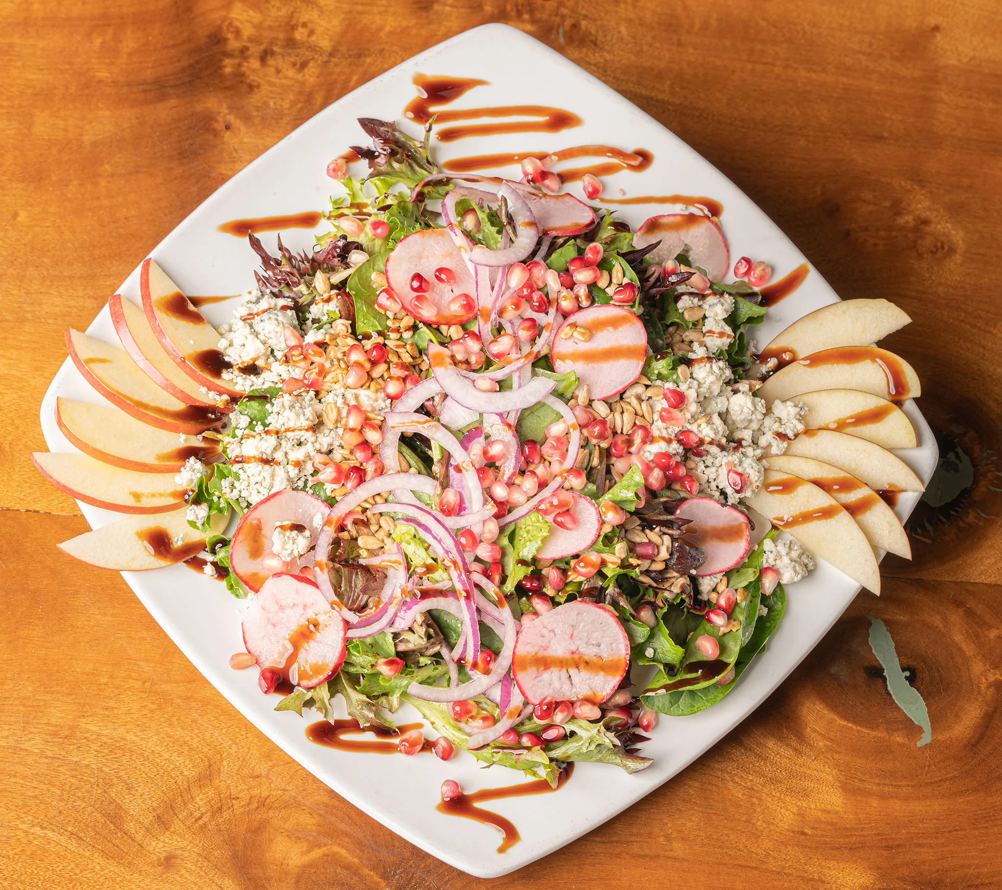 Colorful garden salad with apples and pomegranate