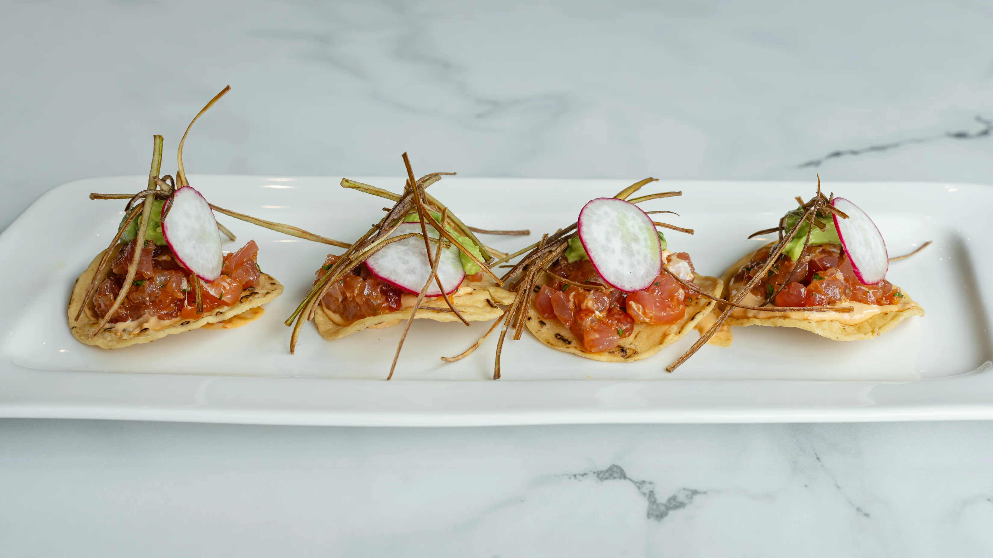Mexican tostadas topped with fresh salsa and garnishes