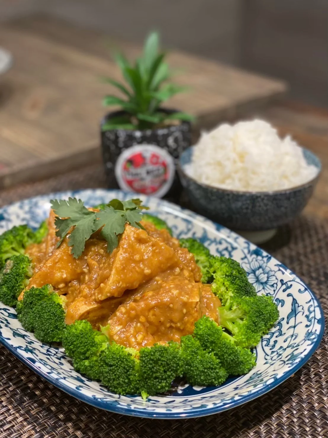 Sesame chicken served with broccoli and rice