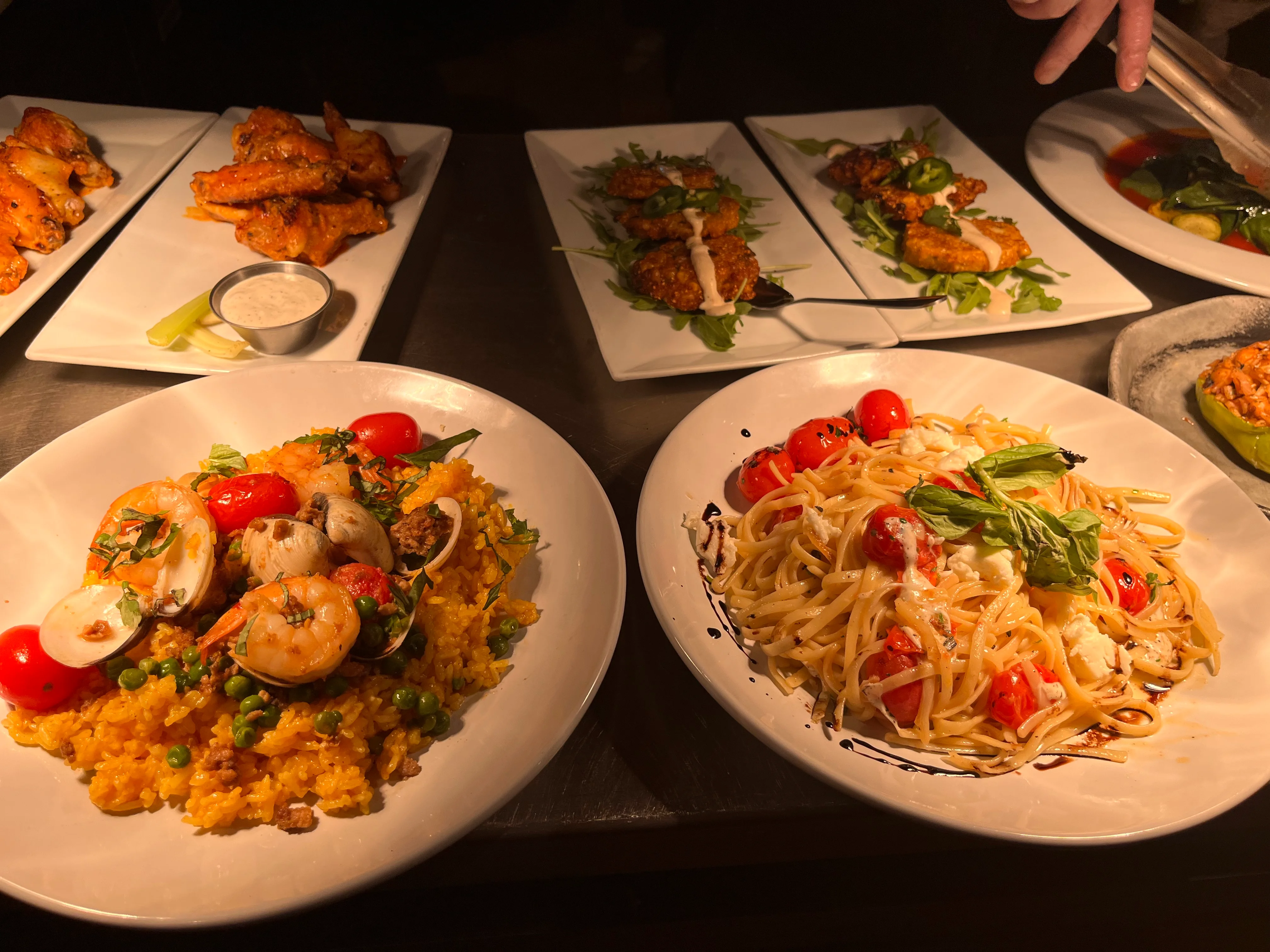 Seafood paella and linguine pasta in a cozy restaurant setting