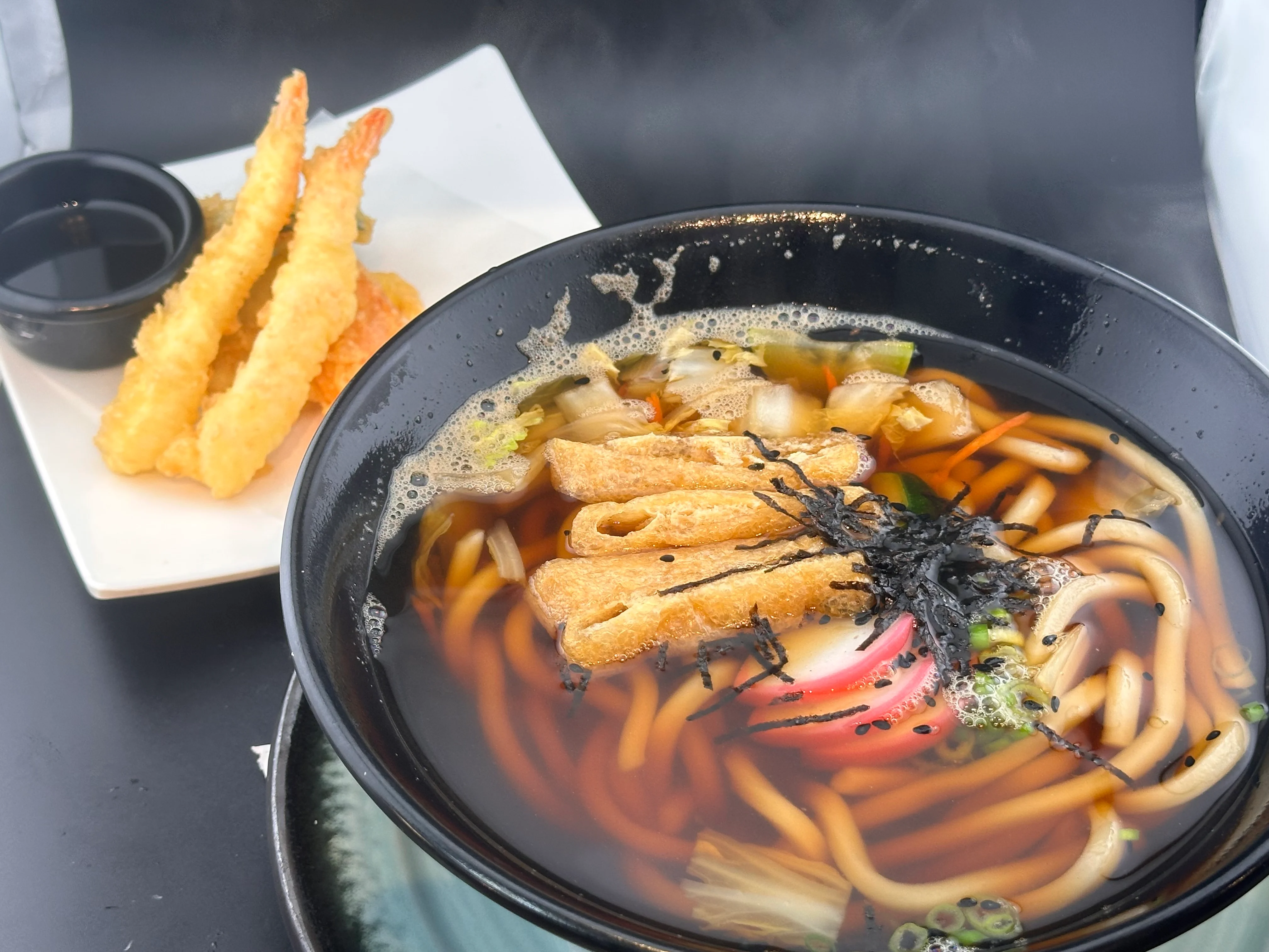 Japanese udon noodle soup with tempura shrimp on the side