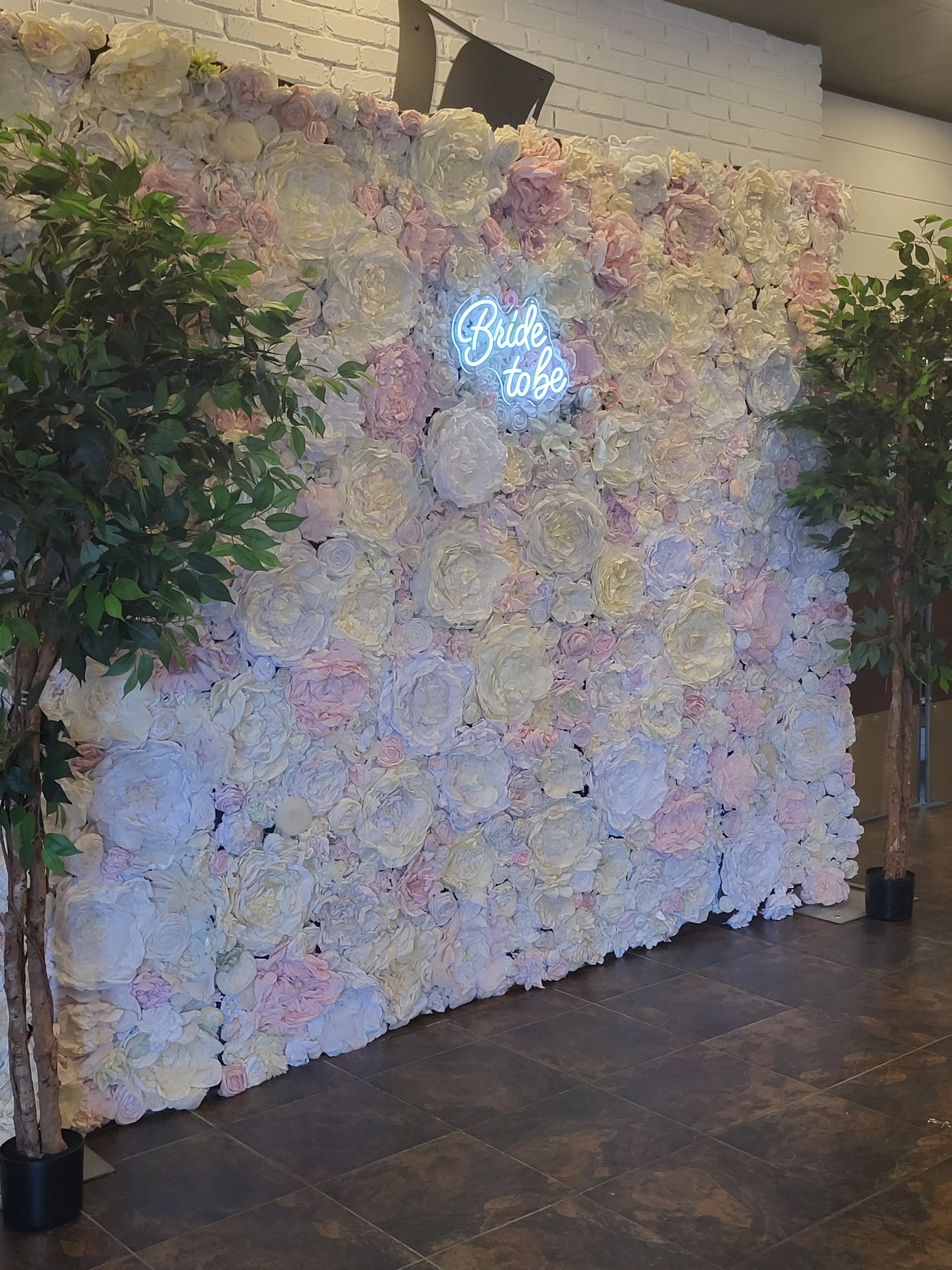 Elegant floral backdrop for bridal events with neon sign