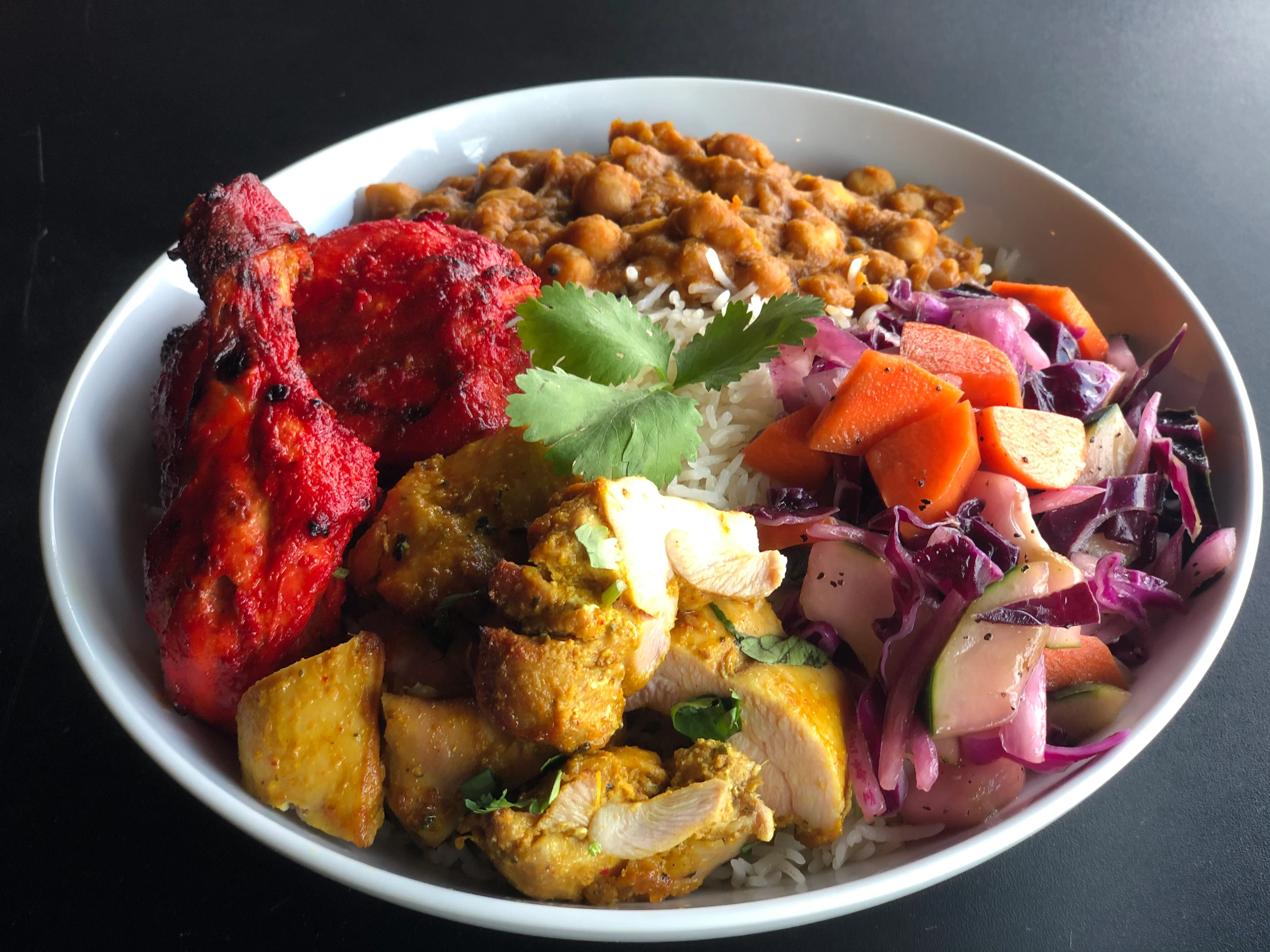 Indian tandoori chicken platter with rice and salad