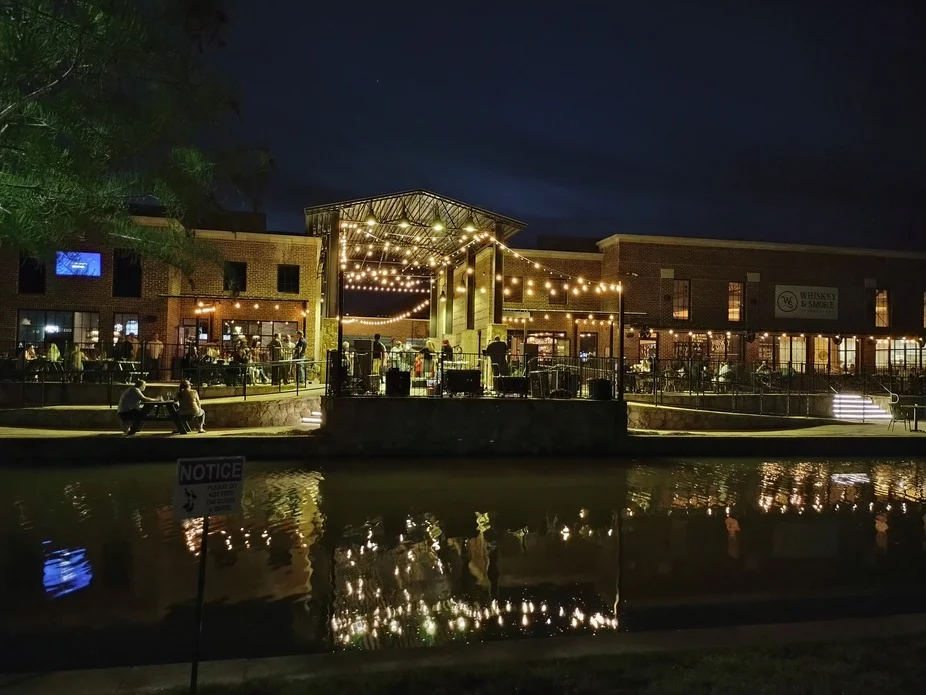 Charming restaurant exterior with string lights at night