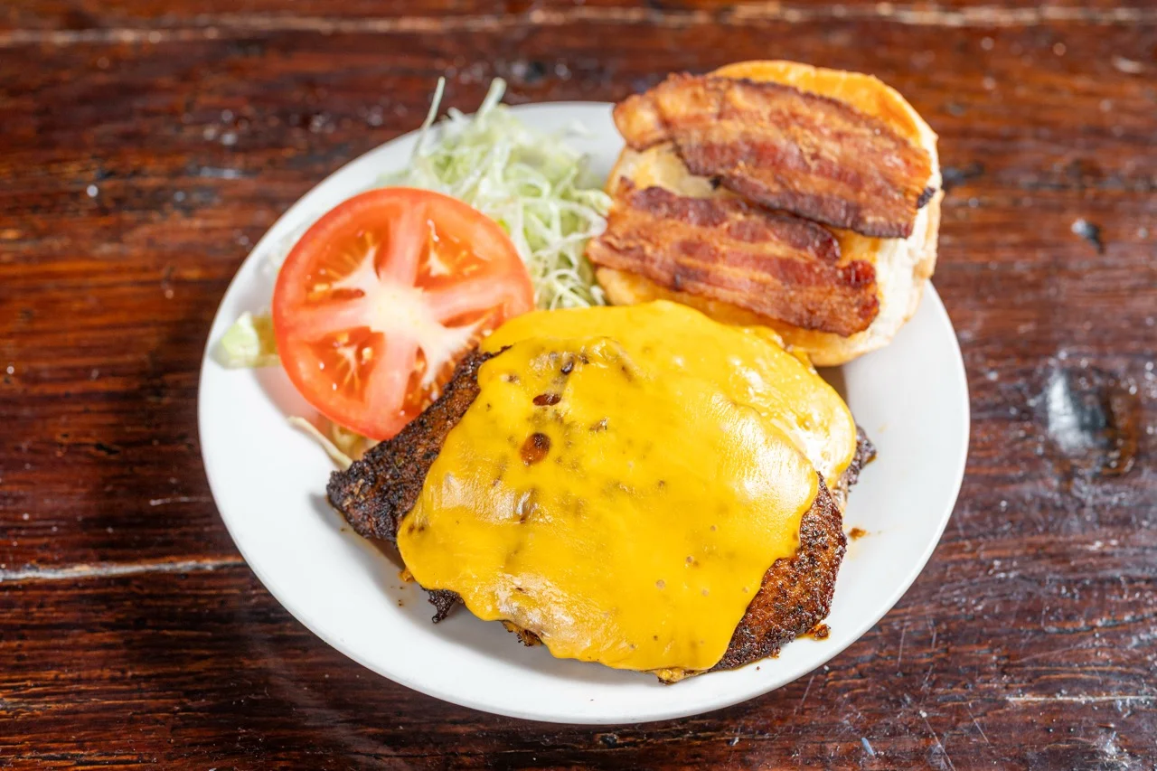 Cheeseburger with bacon and fresh toppings on a plate