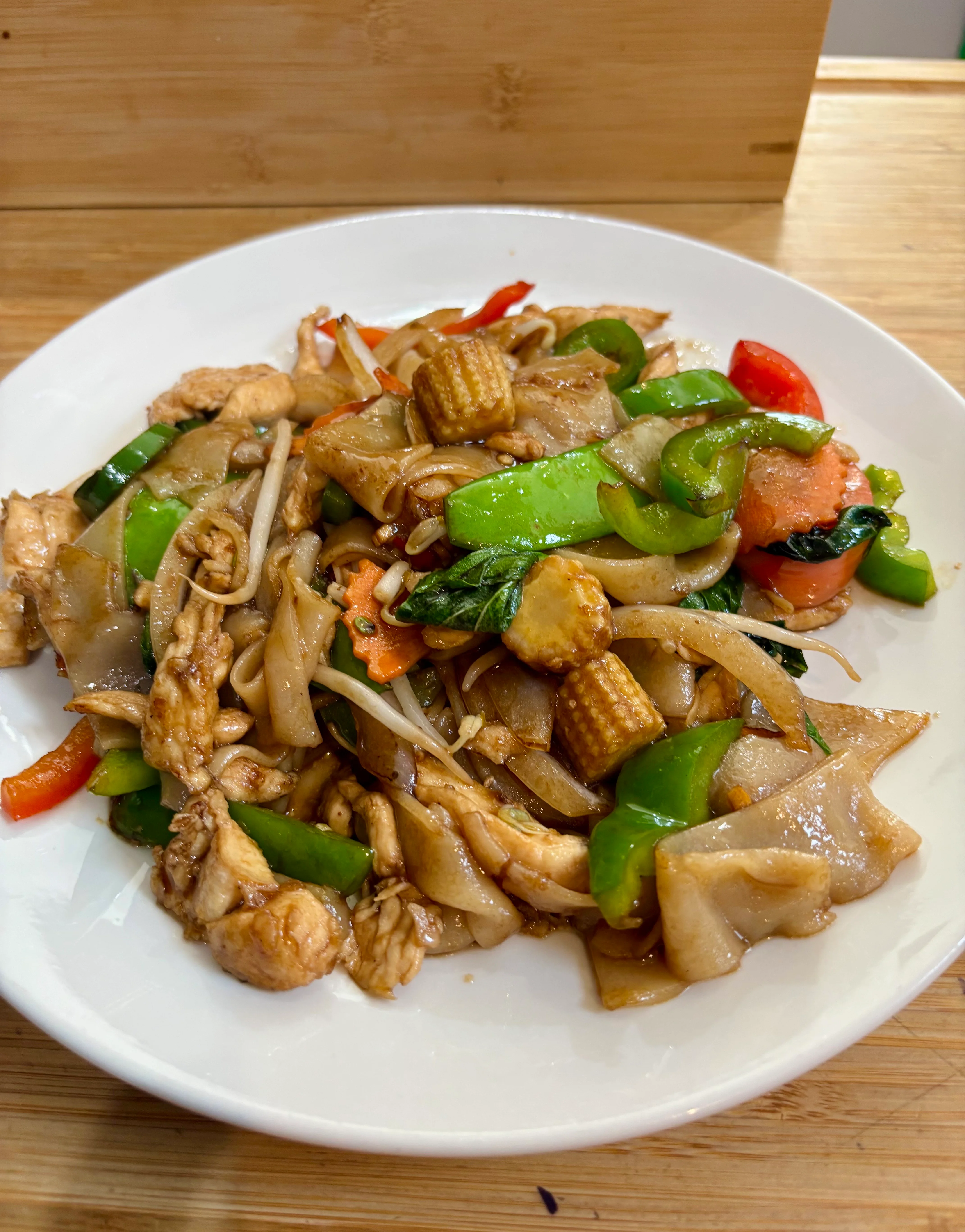 Stir-fried Thai pad see ew with chicken and vegetables