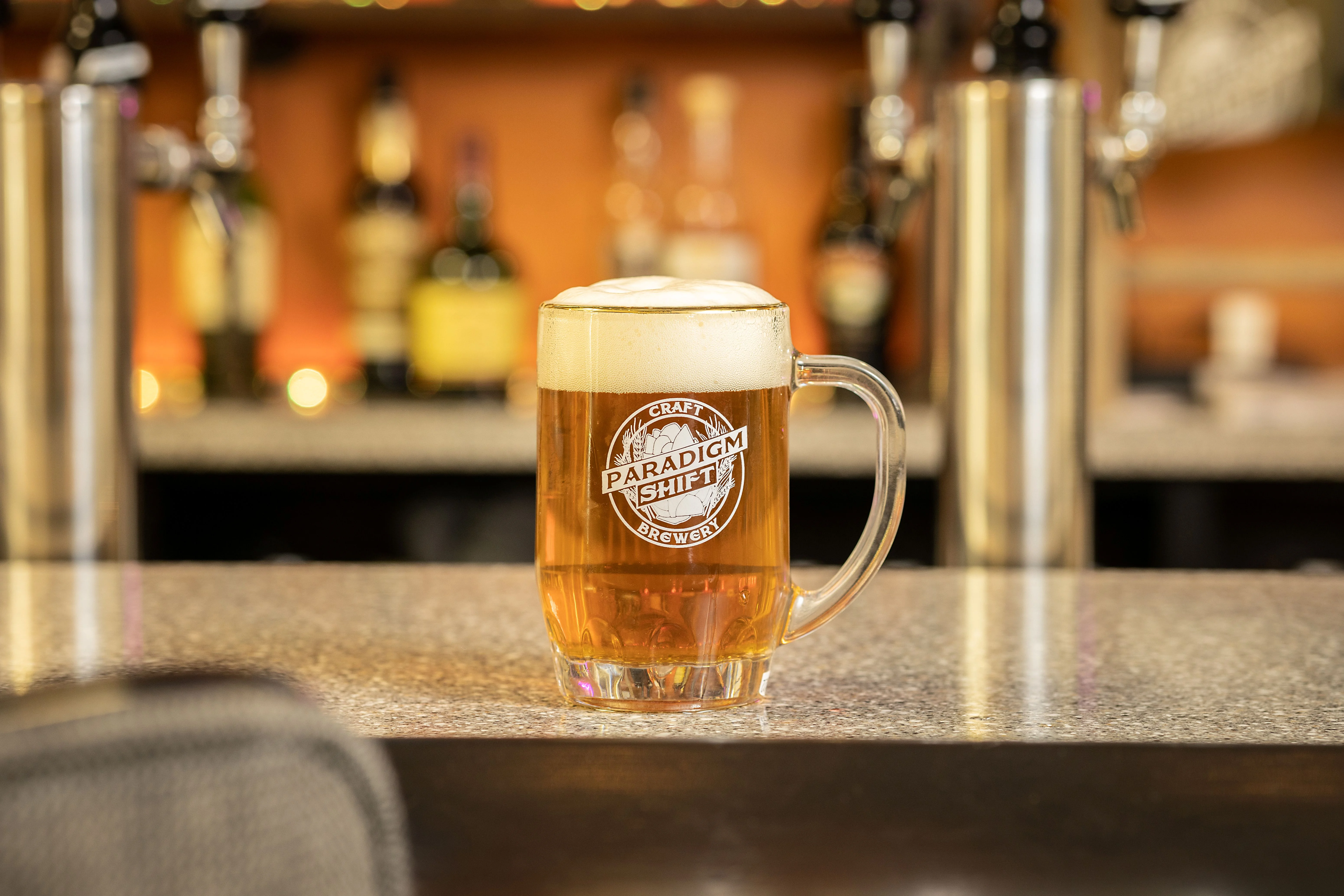 Craft beer in a glass mug at a bar counter
