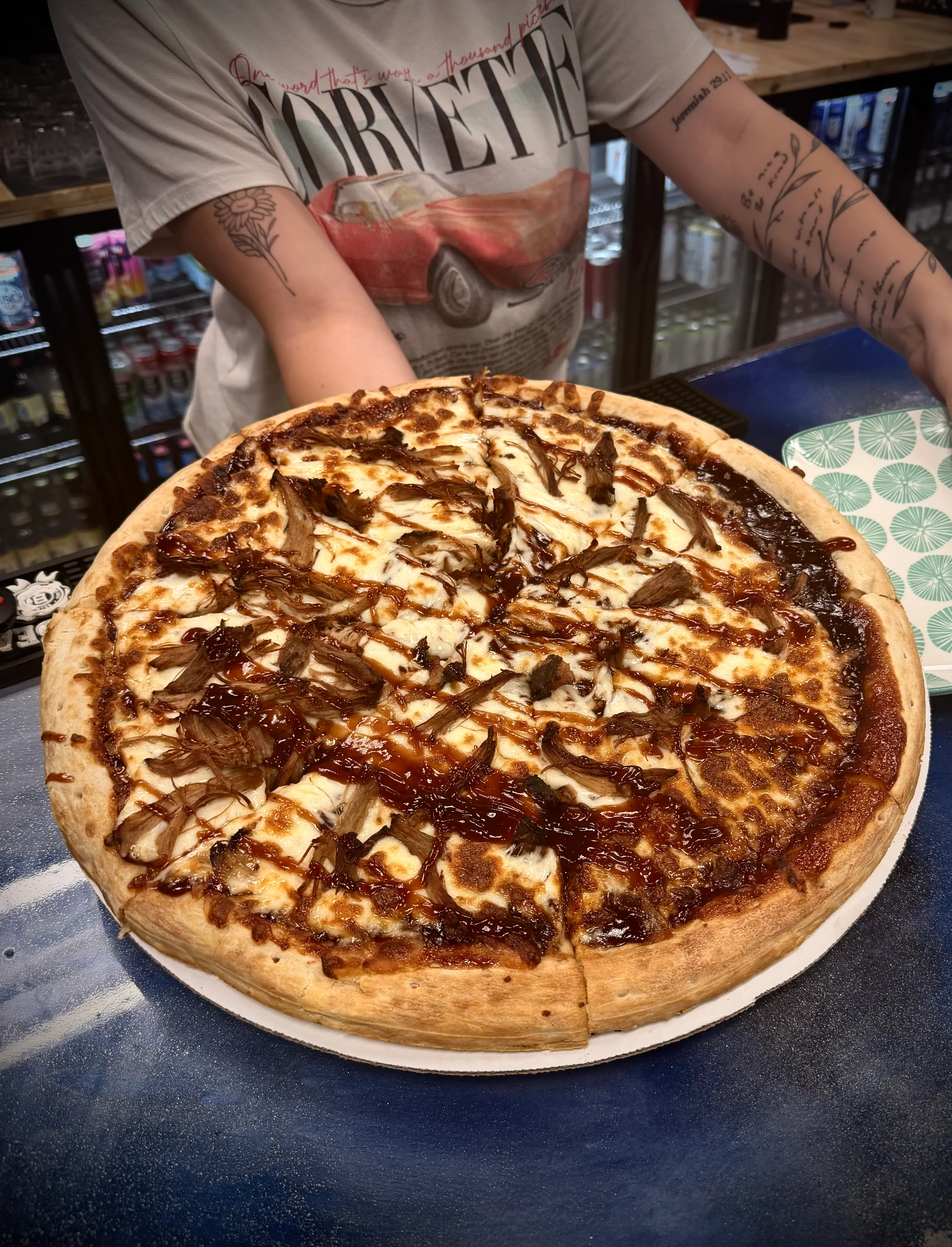 BBQ chicken pizza with a crispy crust and drizzled sauce