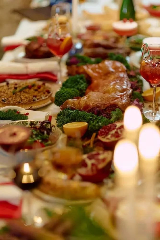 Shared catering table with roast meat and salads