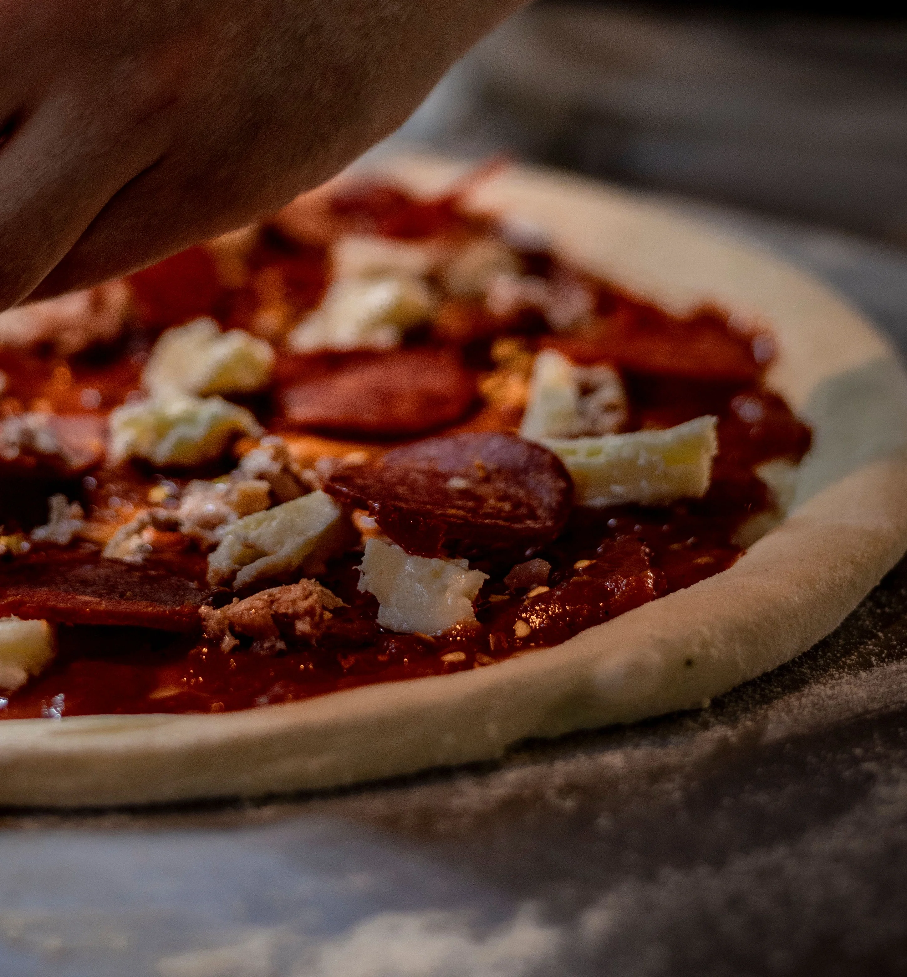 A slice of cheesy pizza with fresh basil, showcasing melted cheese and a crispy crust.