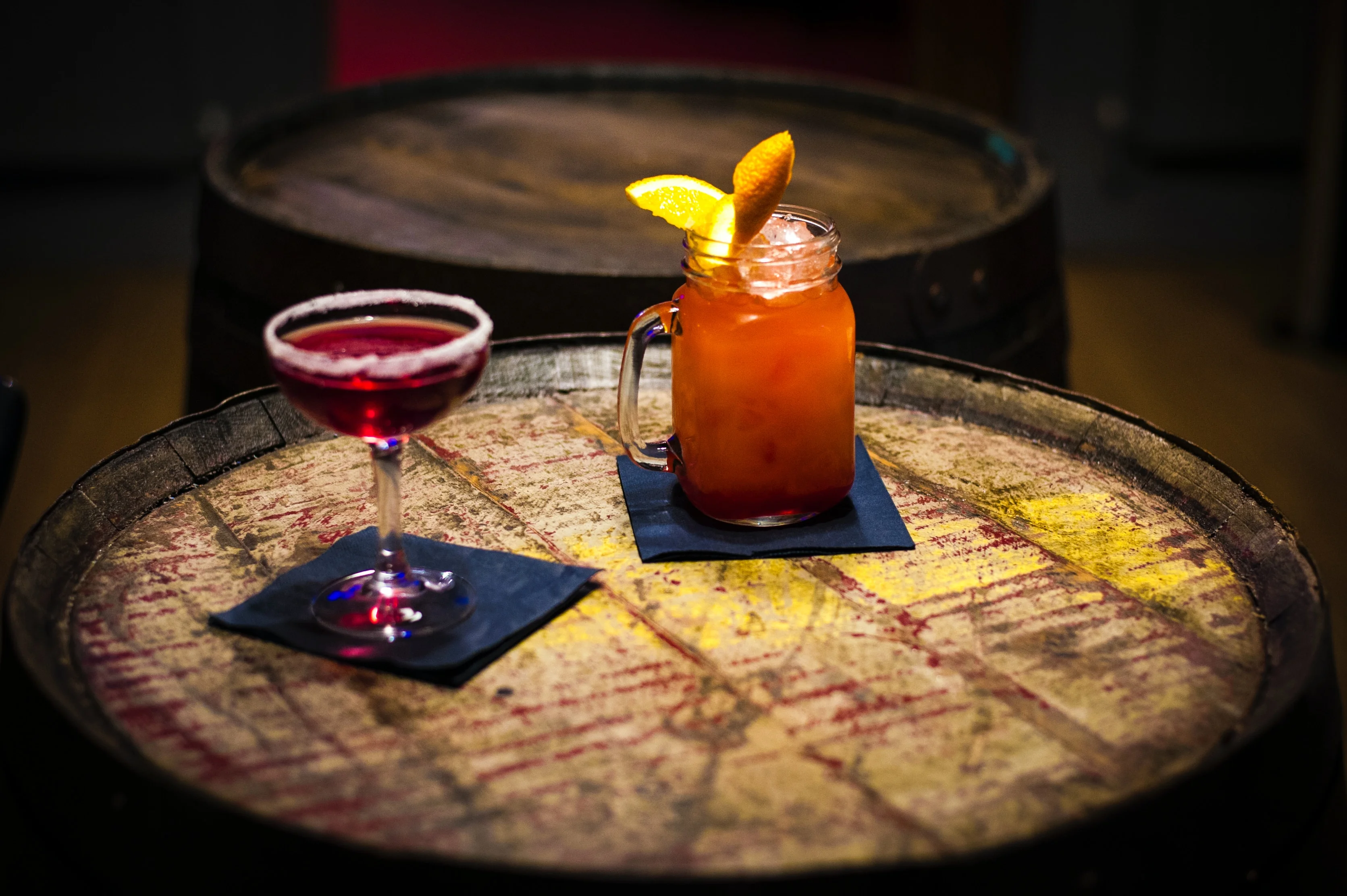 Colorful cocktails on a rustic wooden barrel table