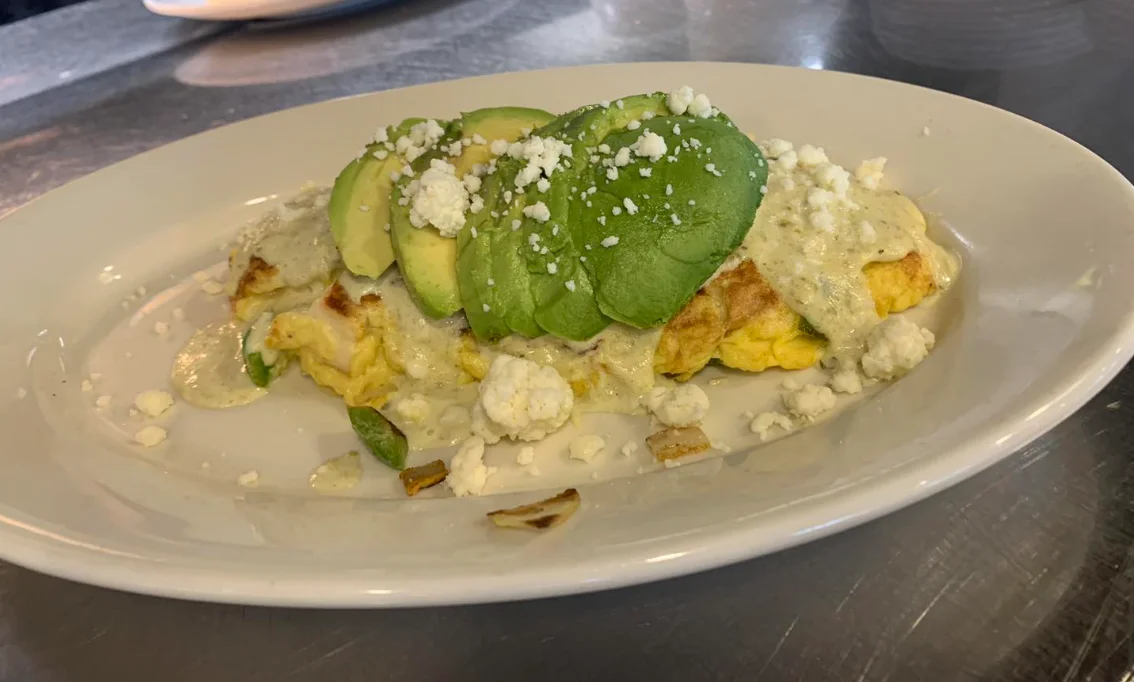 Delicious Mexican omelette topped with avocado and cheese