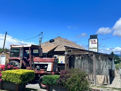 Charming restaurant exterior with tractor and vibrant flowers