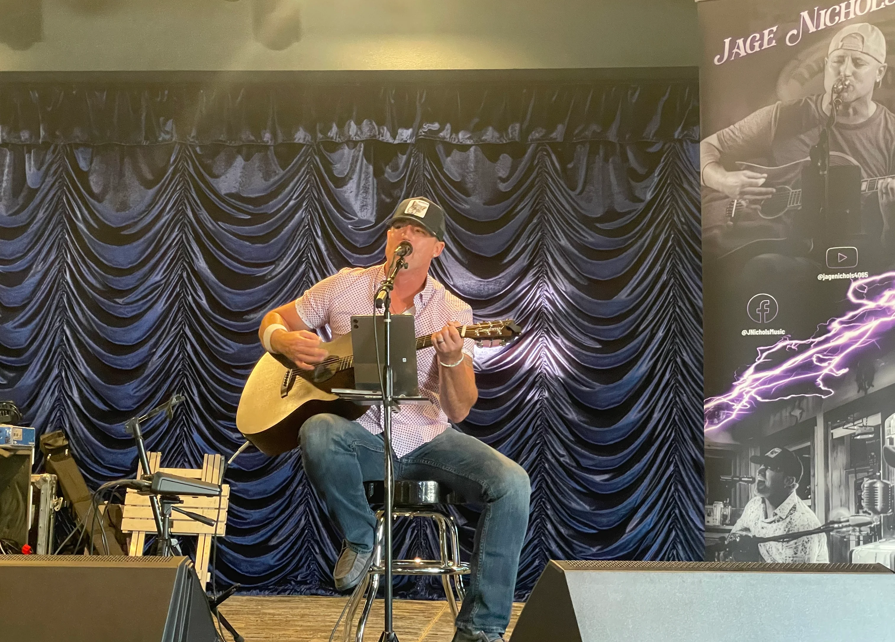 Live music performance with acoustic guitar on stage