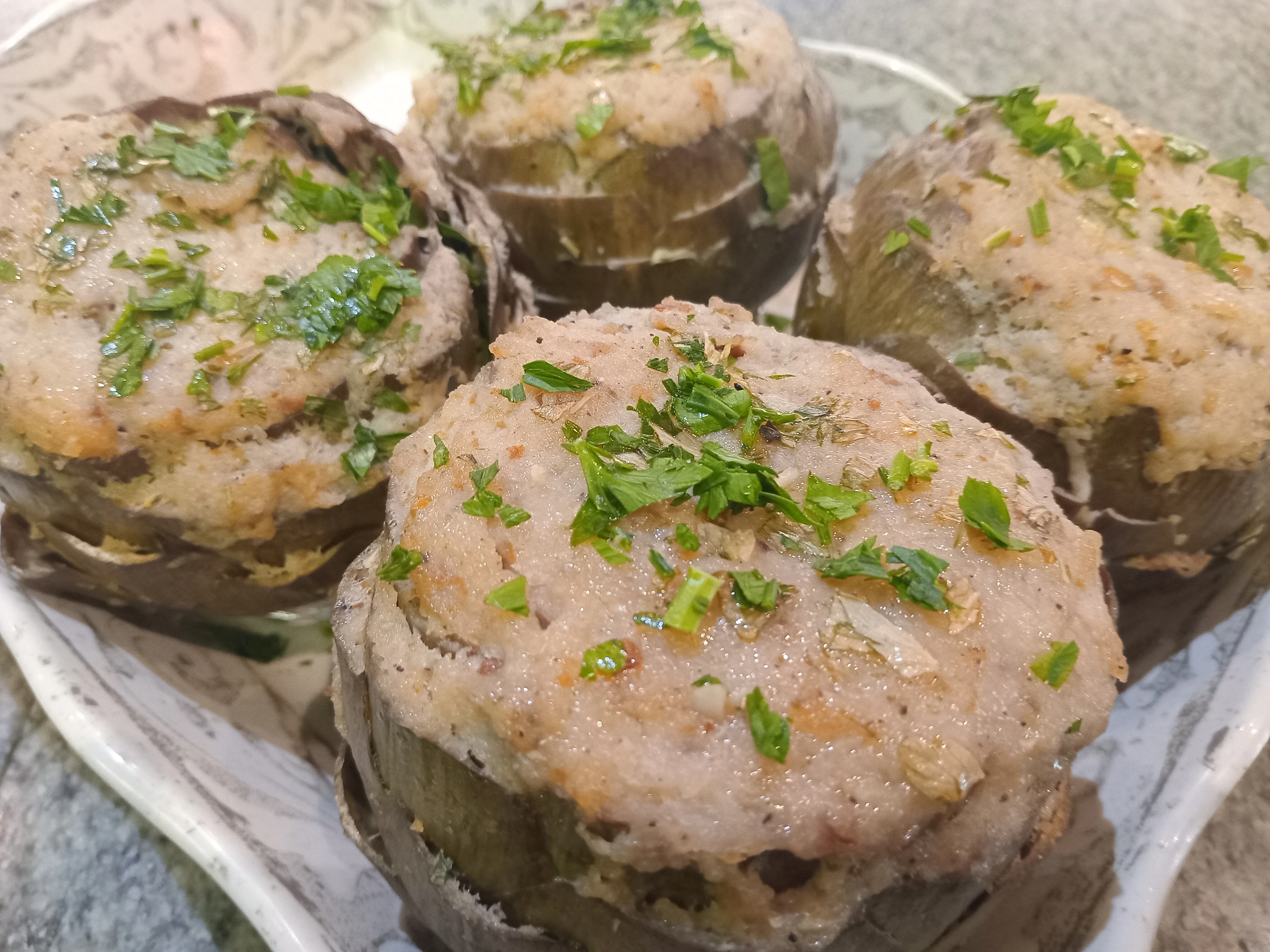 Stuffed artichokes, a classic Italian dish, garnished with herbs