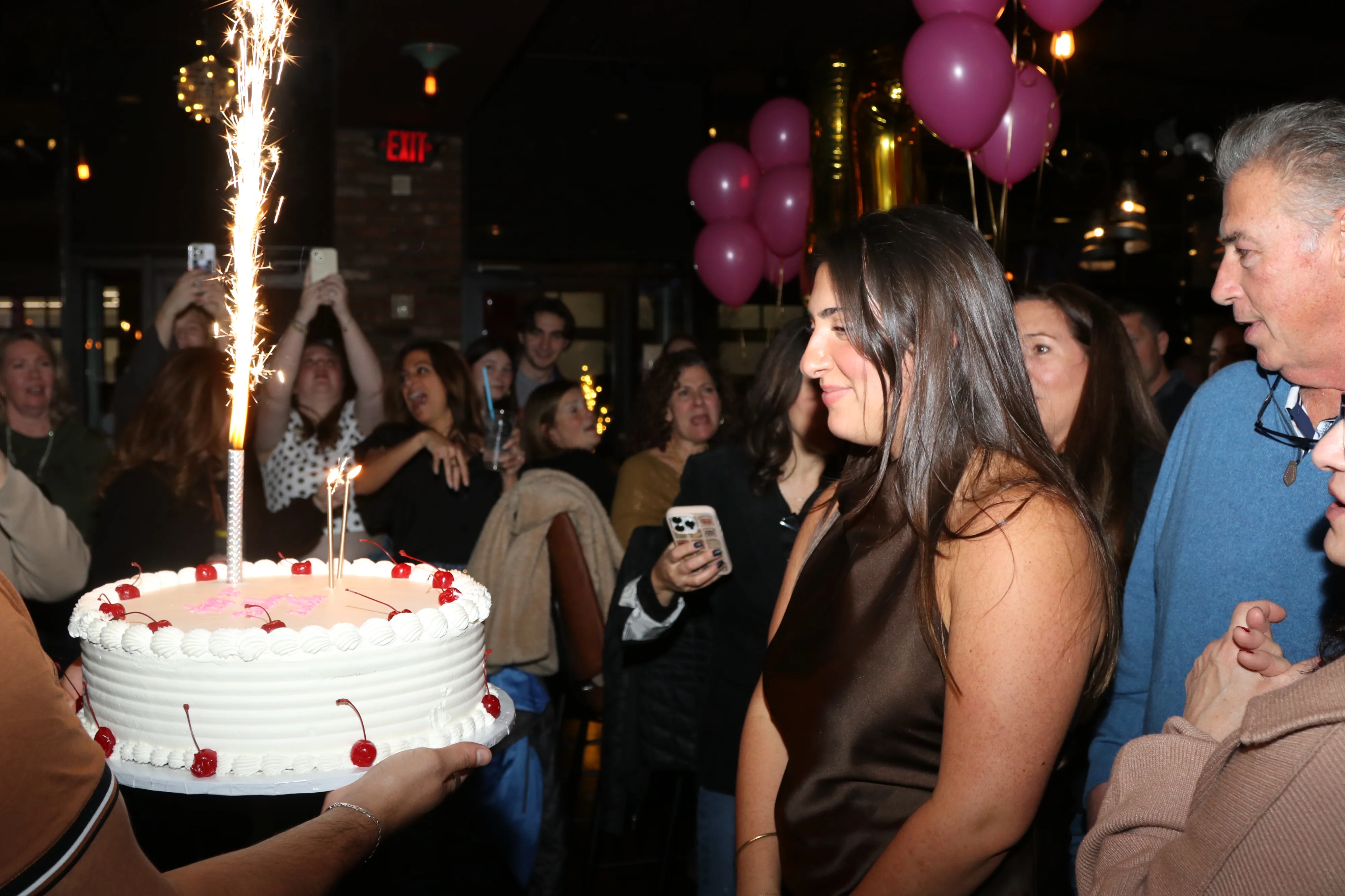 Team and guests celebrating a birthday event together inside the restaurant