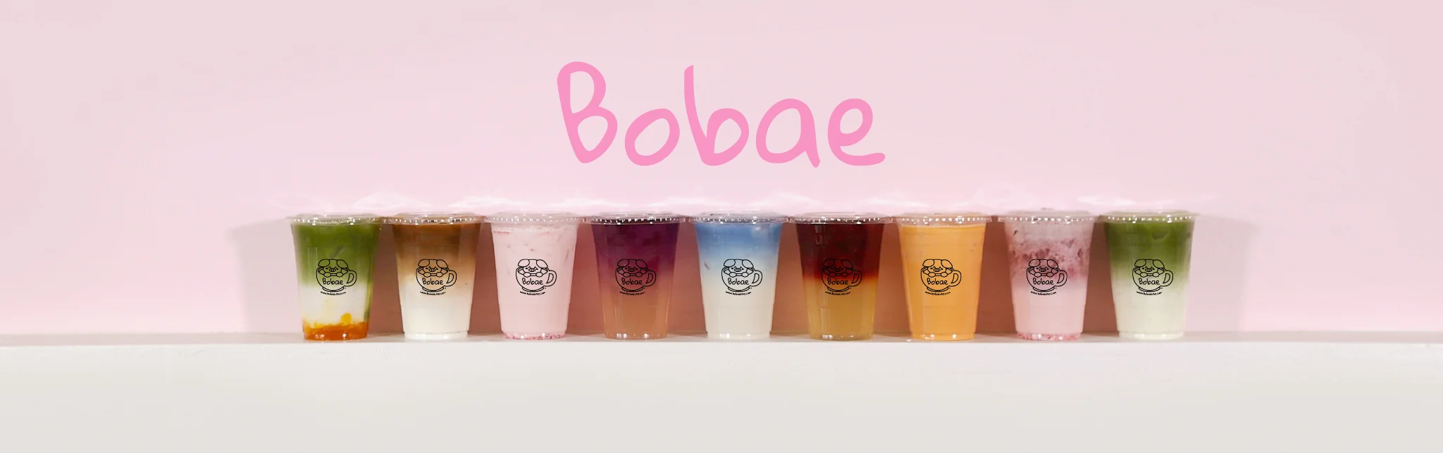 Colorful selection of bubble tea drinks on a pastel background