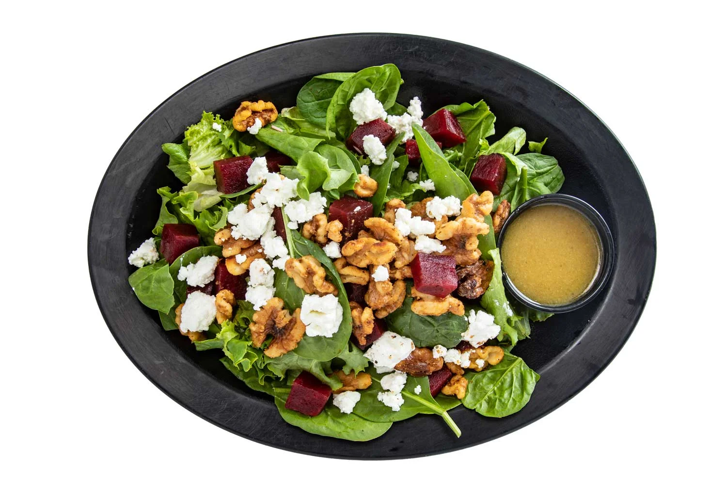 Fresh spinach salad with beets and walnuts, a healthy Mediterranean dish