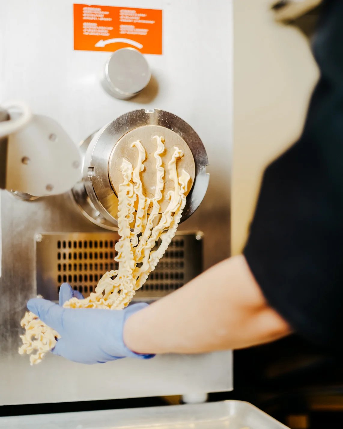 Freshly extruded pasta from a pasta machine