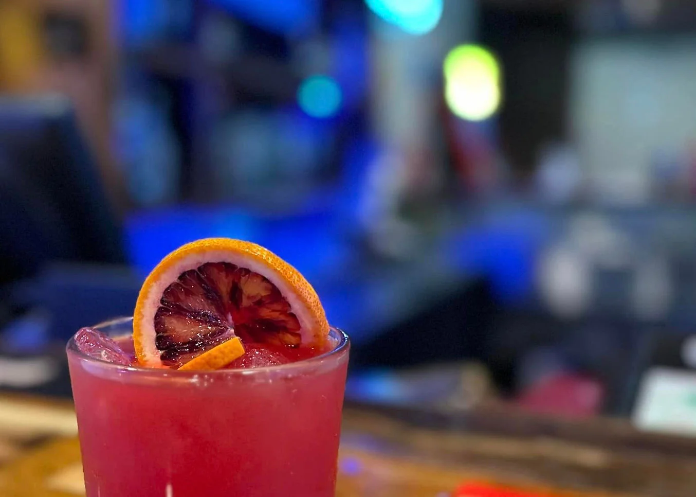 Colorful cocktail garnished with blood orange slice