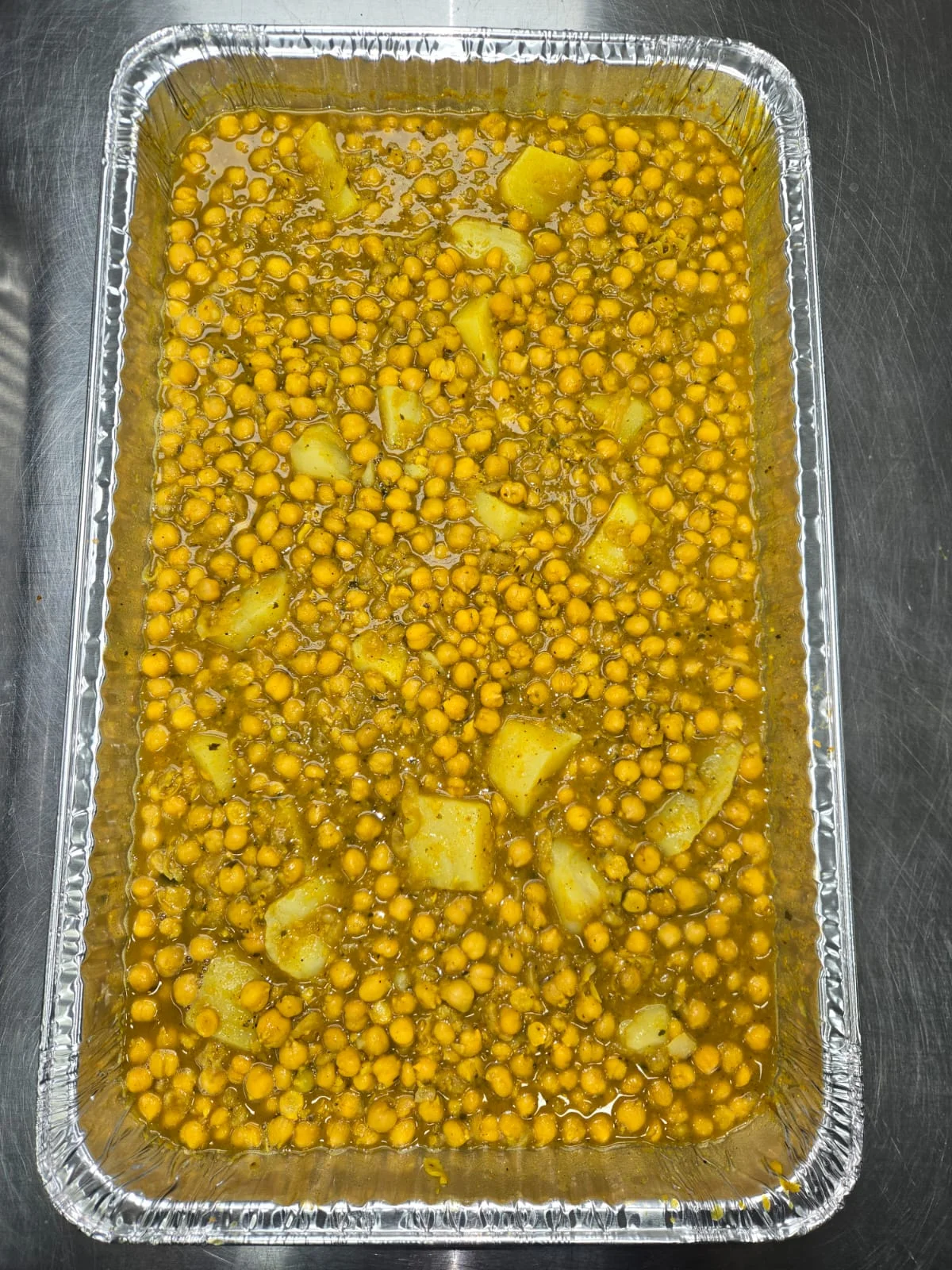 Savory Indian chana dal with potatoes in a large tray