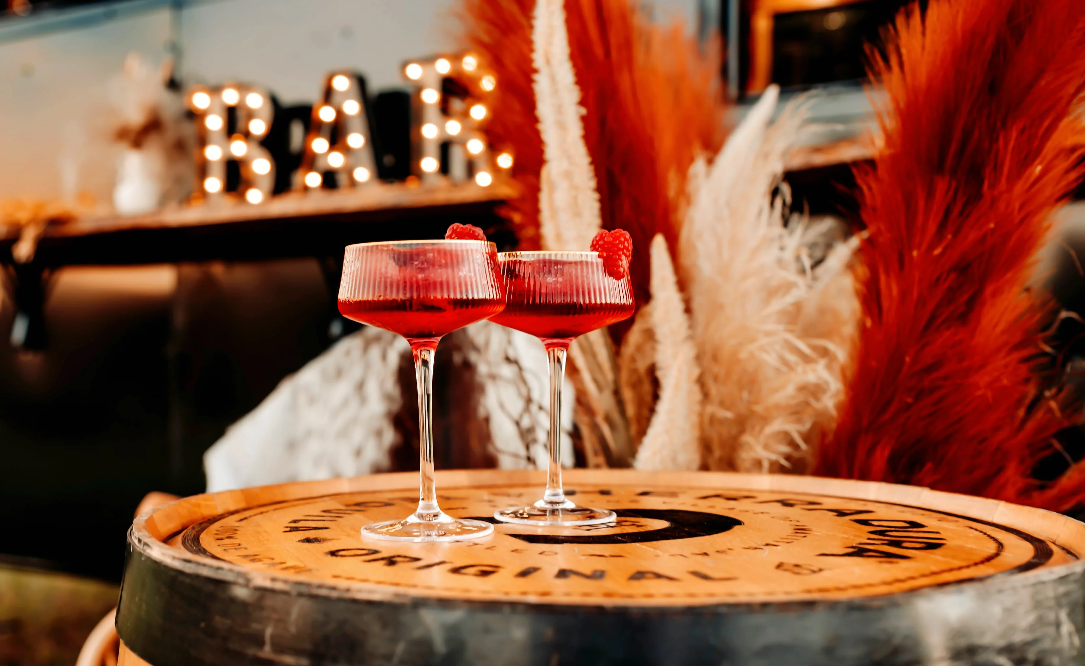 Elegant cocktails on a wooden barrel at a stylish bar