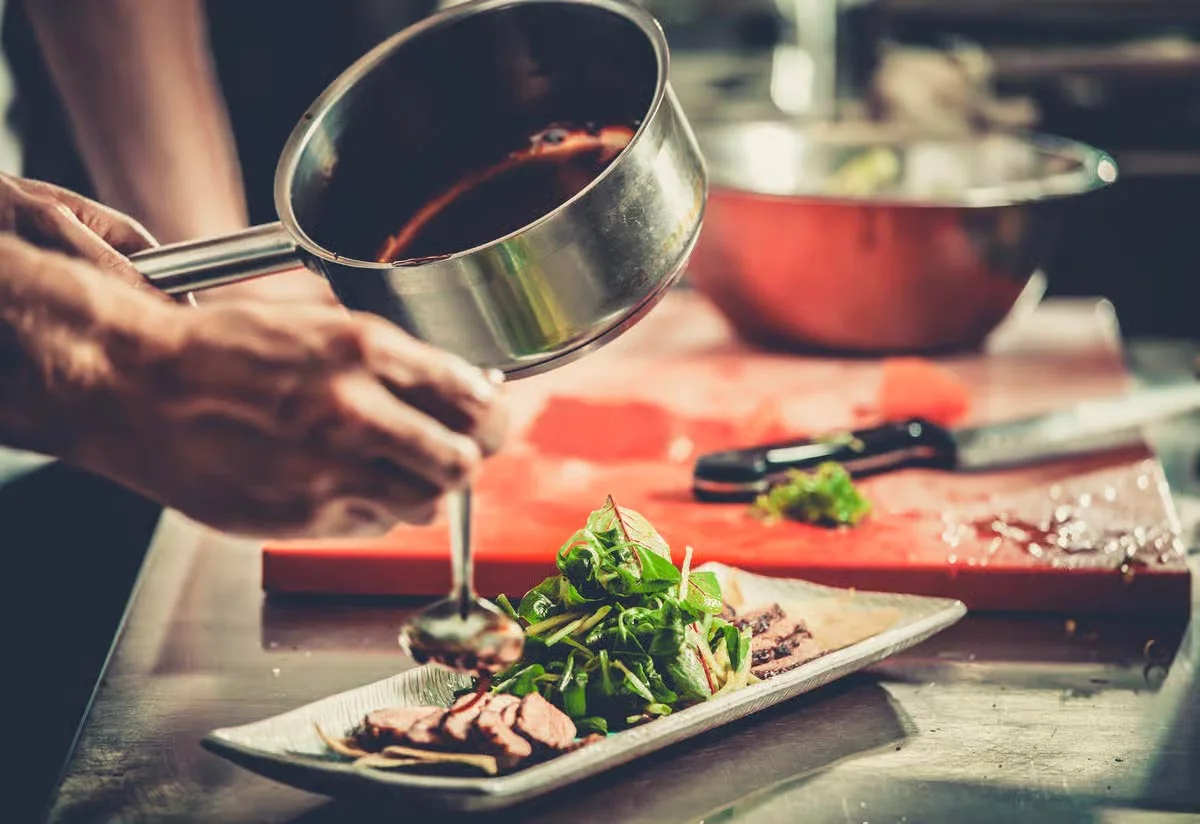A restaurant chef preparing a dish