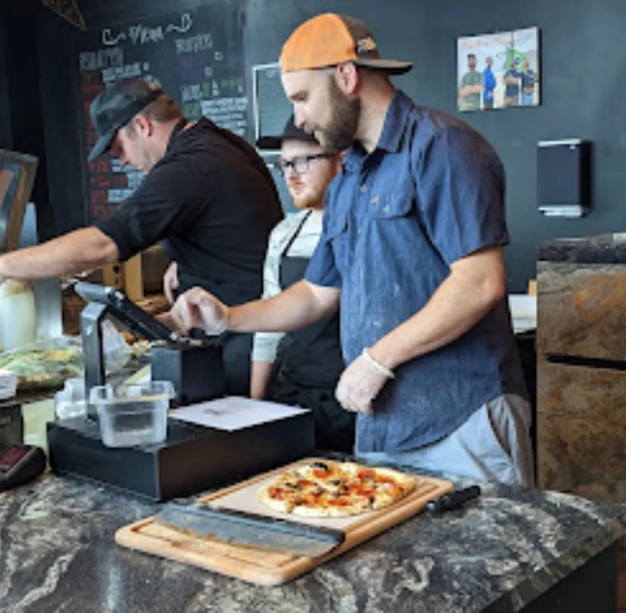 Pizza being prepared in a modern pizzeria kitchen