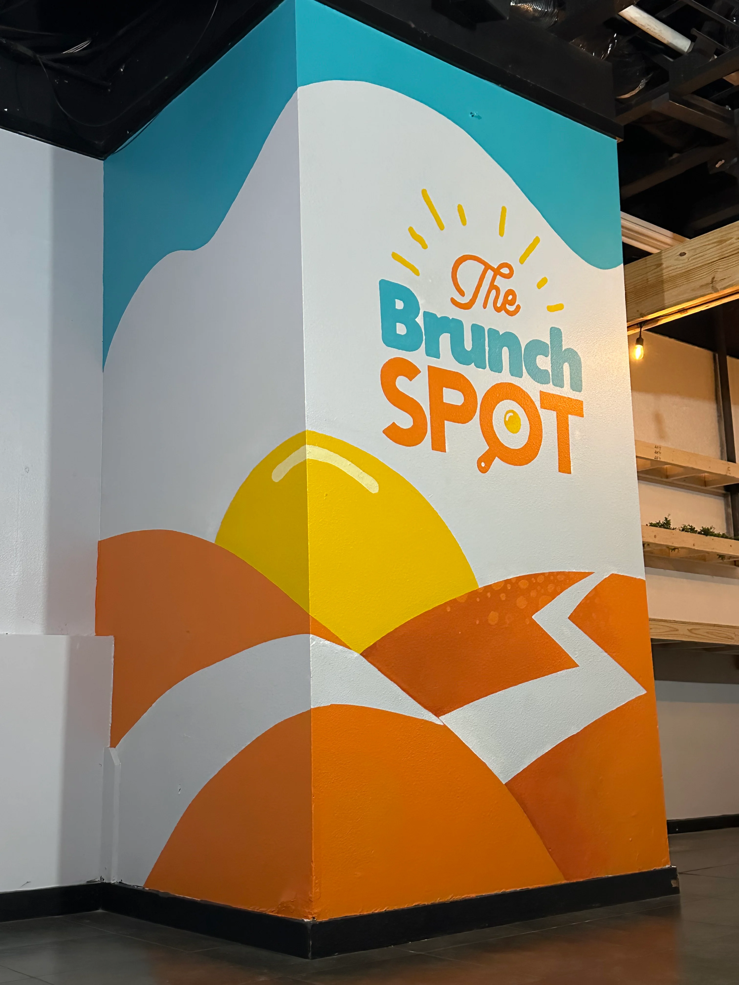 Colorful mural of The Brunch Spot in a modern restaurant interior