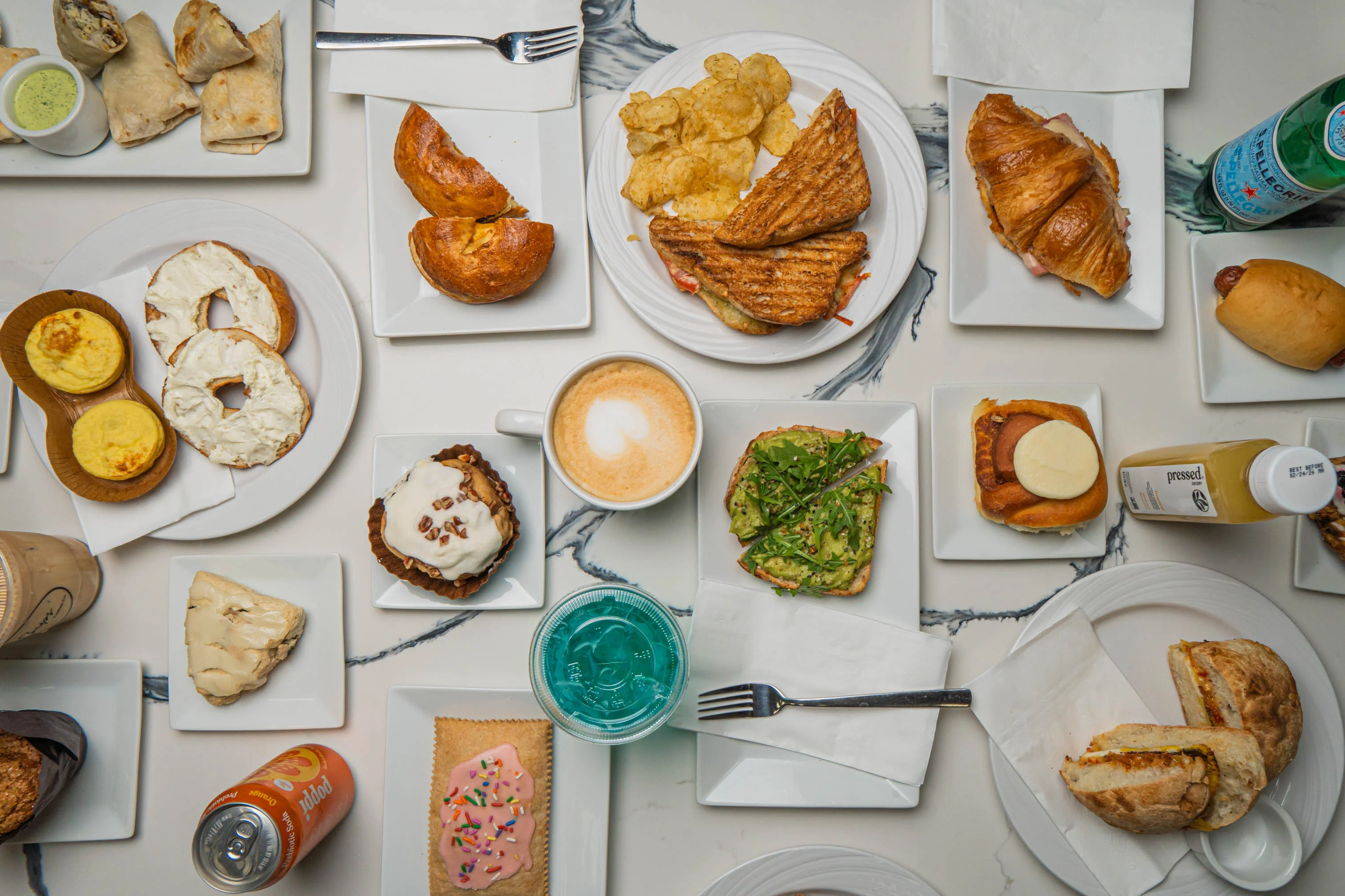 Assorted brunch dishes including pastries and sandwiches