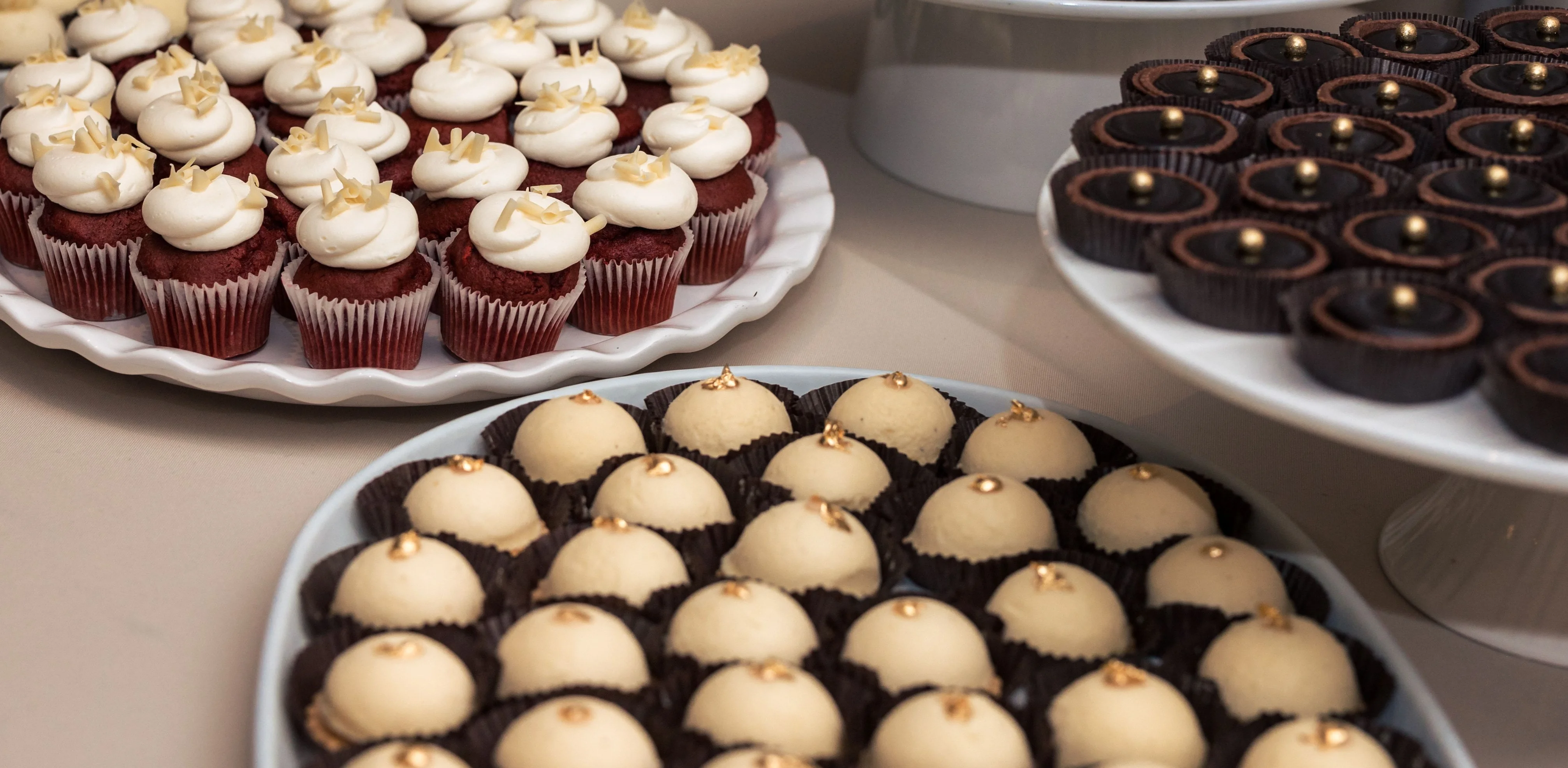 Assorted gourmet cupcakes and confections on display