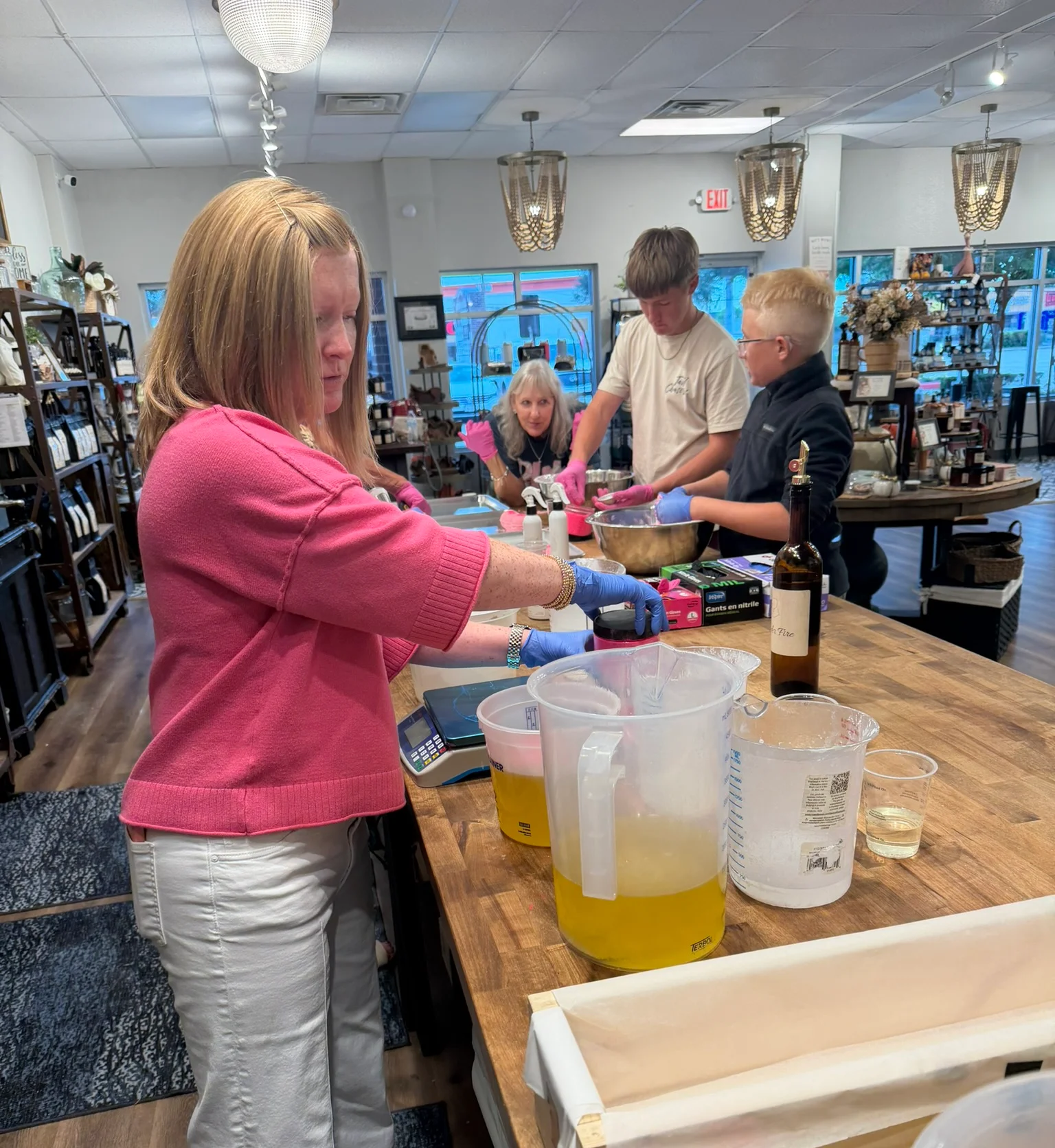 Kajay making Grace Under Fire products with family at Magnolia Ritual
