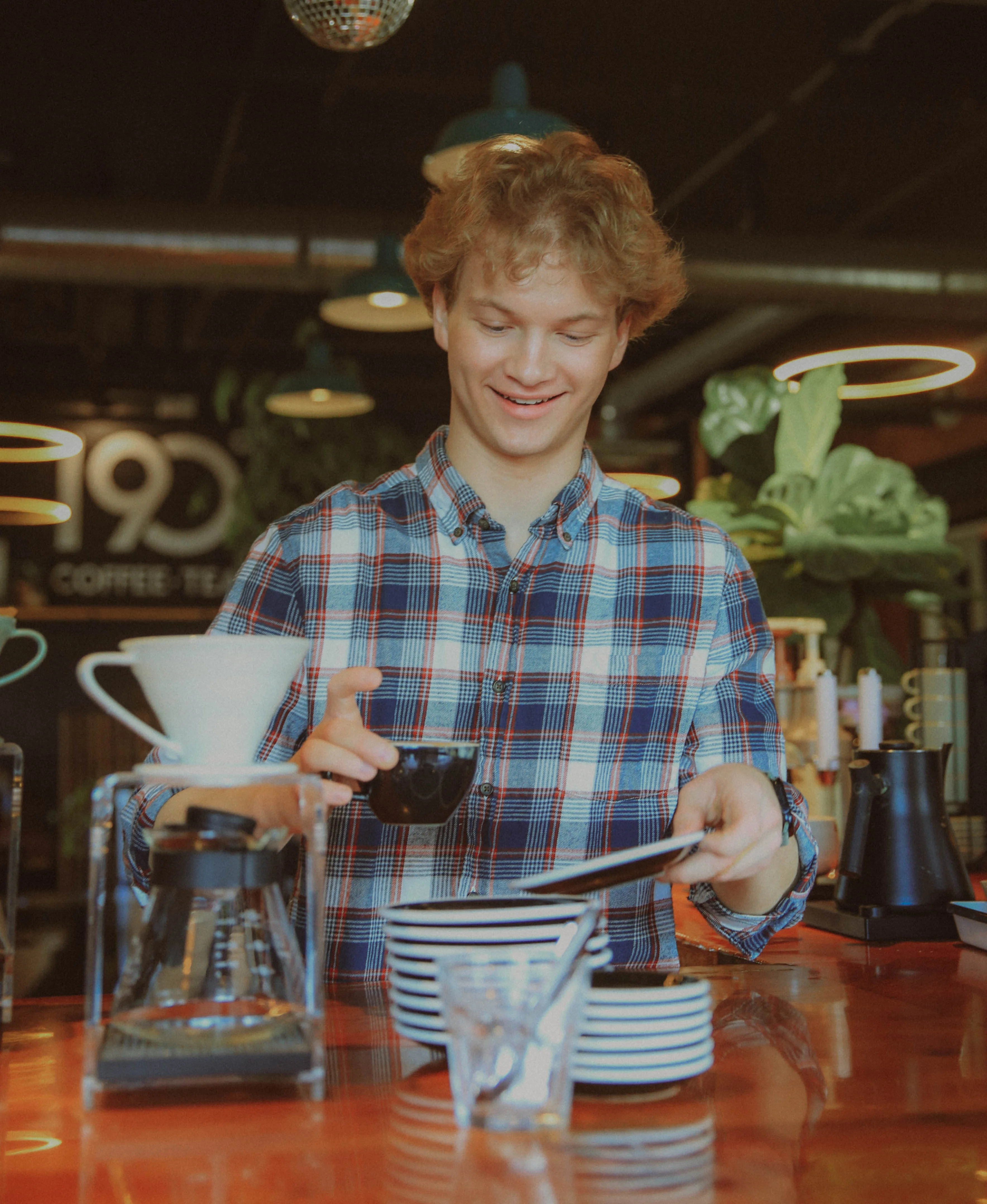 Barista preparing coffee in a modern café setting