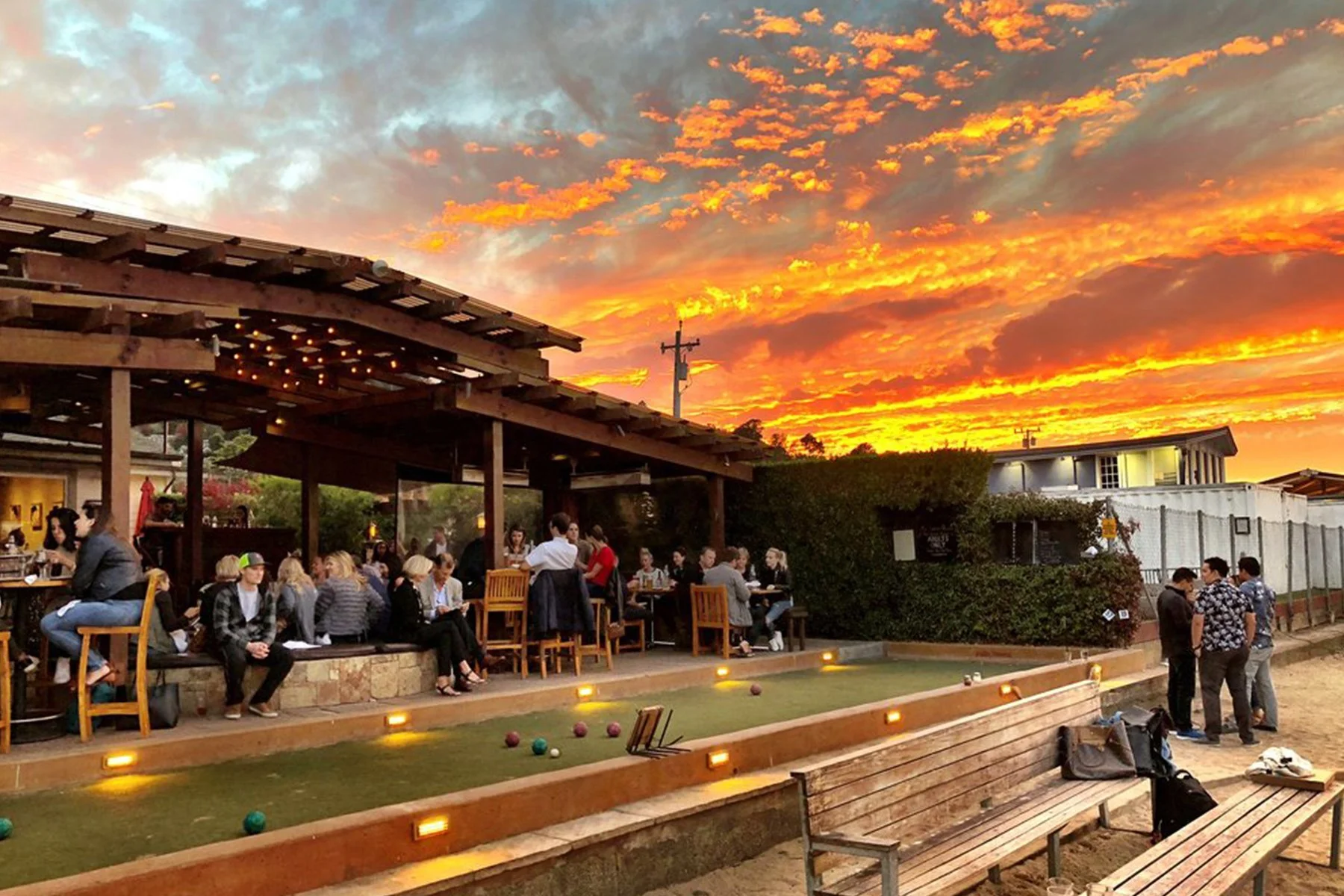 Bar Bocce's back patio, people socializing near the bocce court