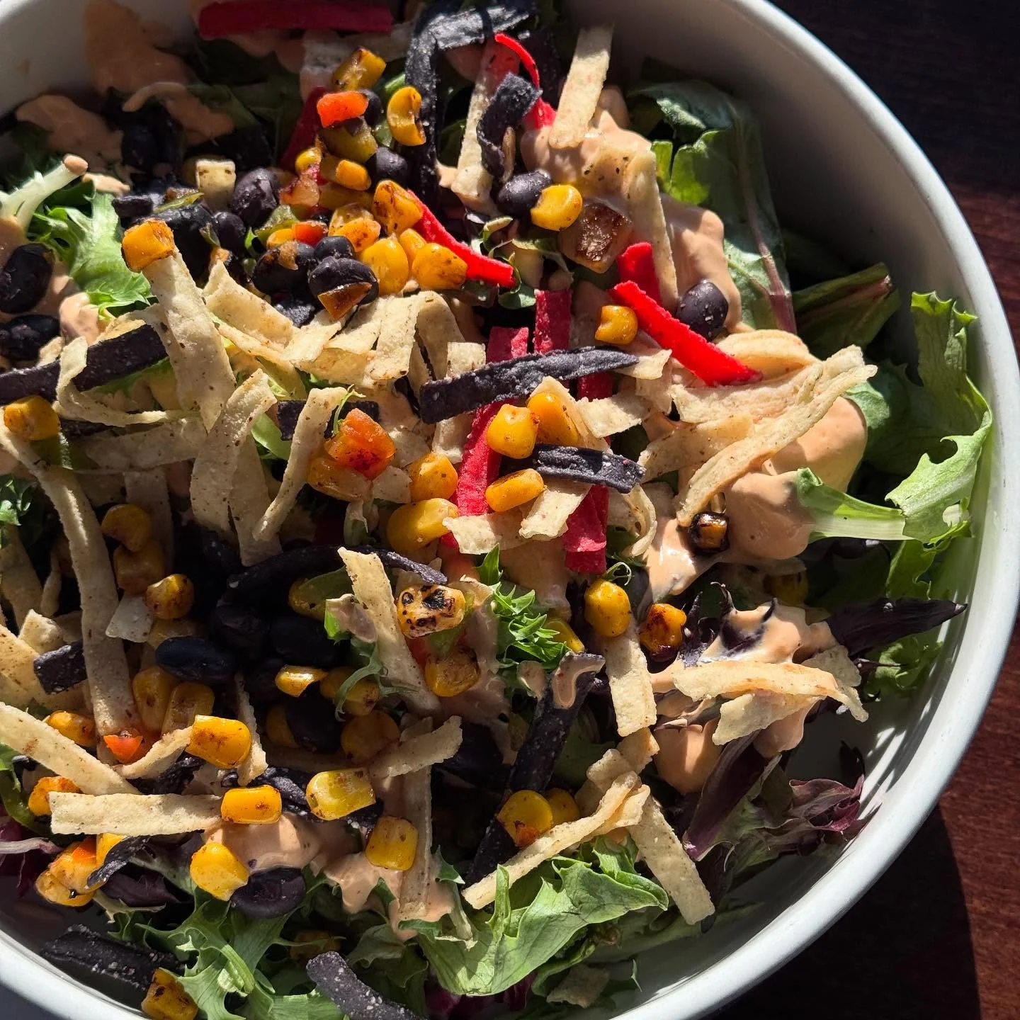 Colorful Mexican salad with black beans and tortilla strips