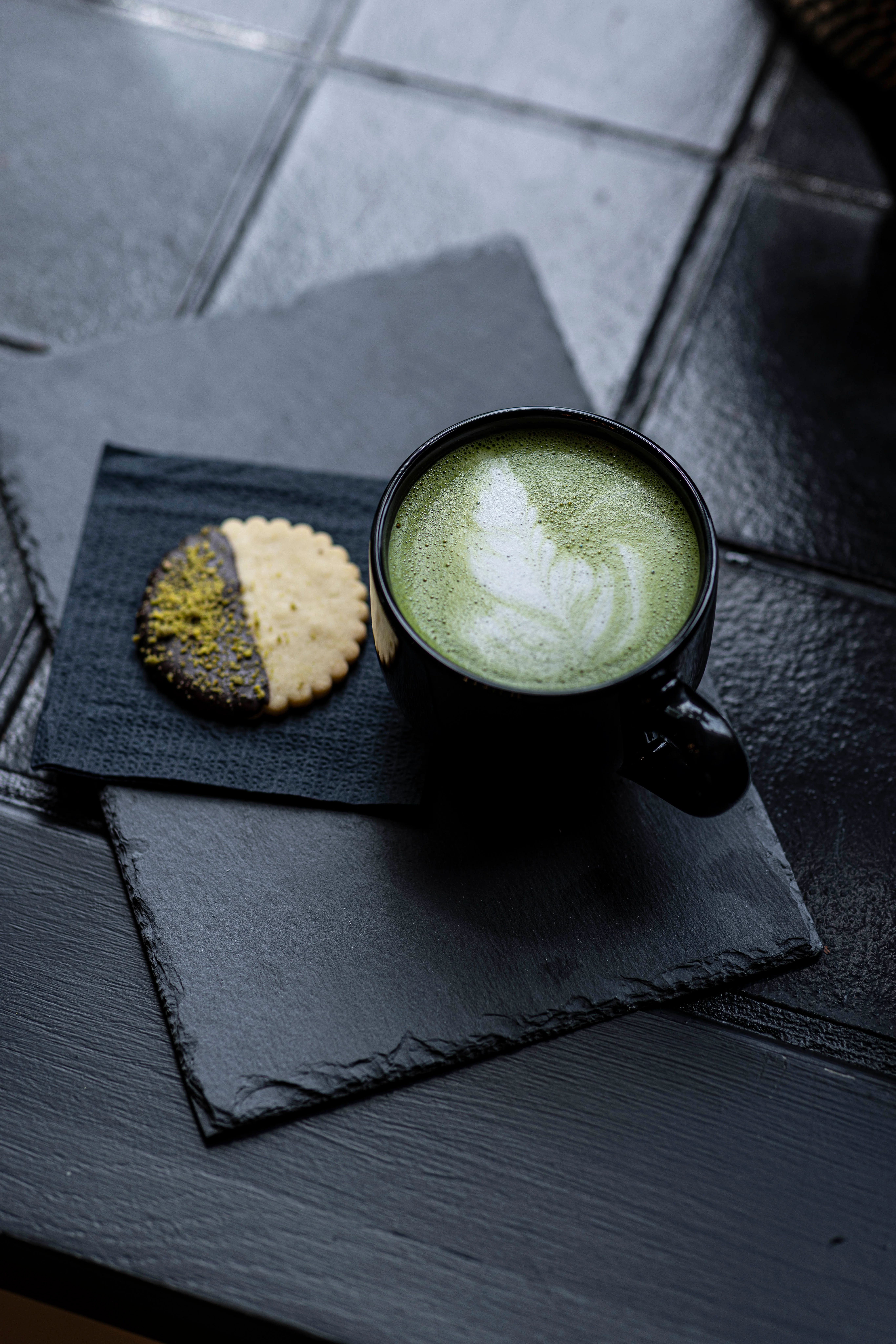 Matcha latte served with a decorative cookie