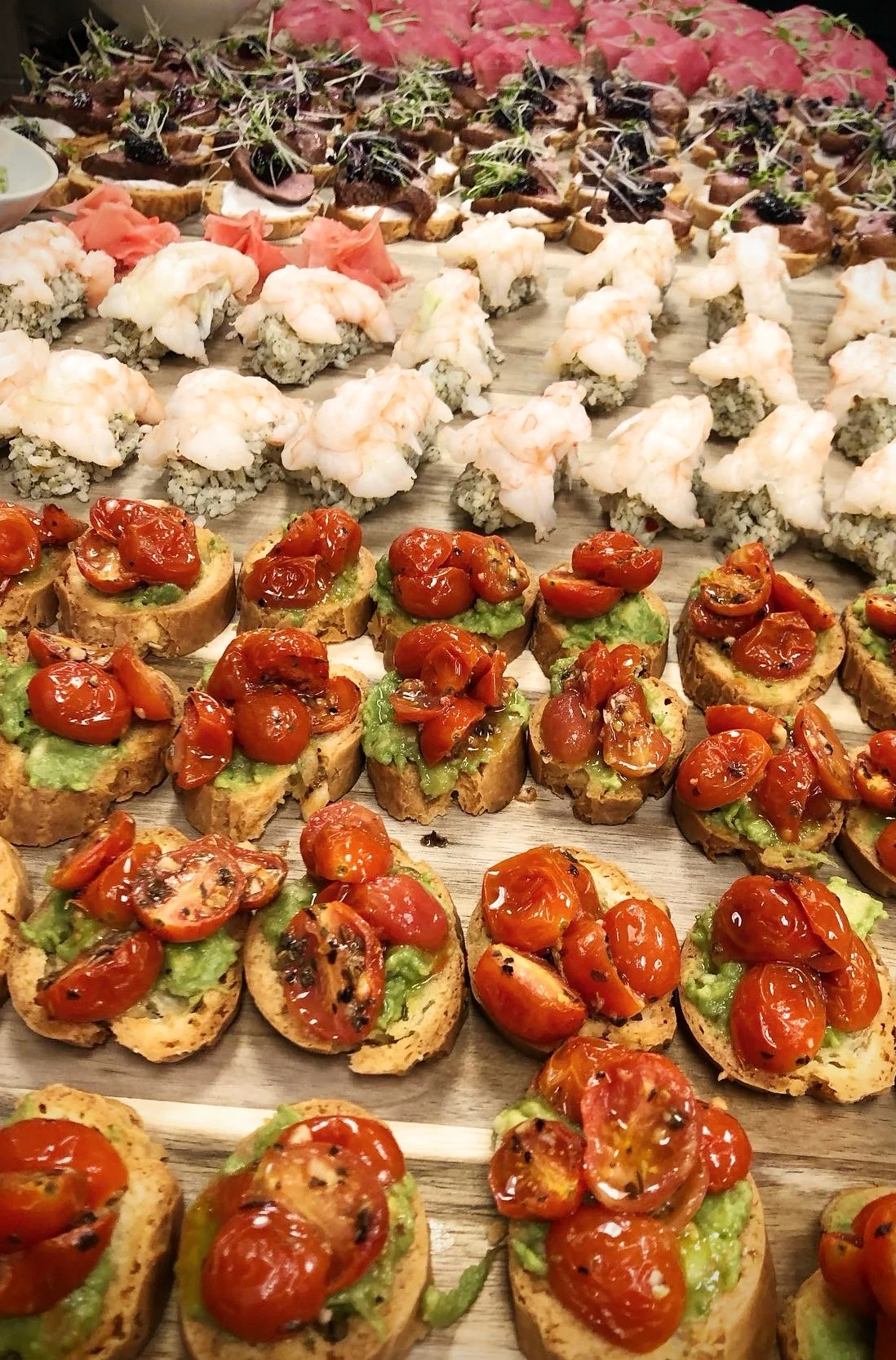 Assorted sushi and bruschetta platter at a gourmet event
