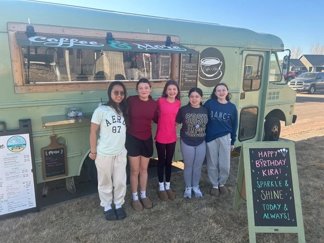 Group of friends celebrating a birthday at a coffee truck