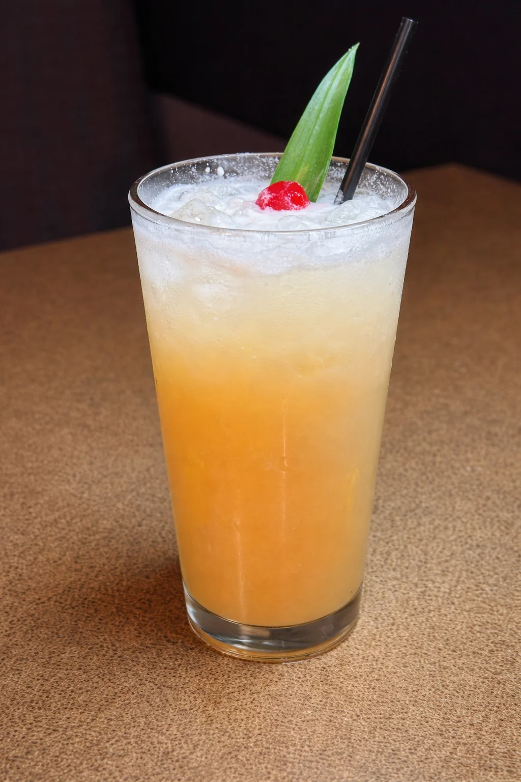 A refreshing Colada cocktail garnished with a slice of pineapple.