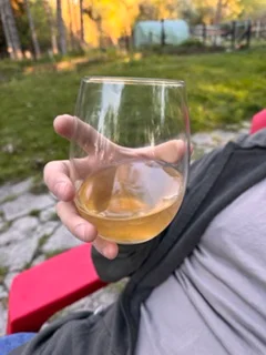 Glass of white wine in a serene outdoor setting