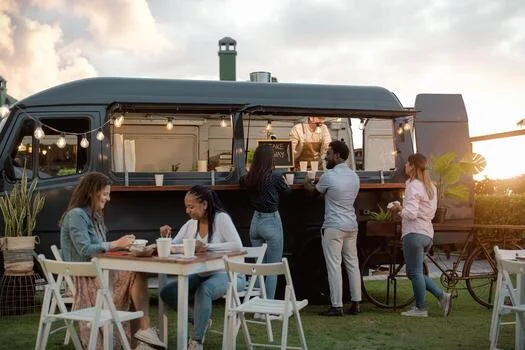 Food truck serving customers in a lively outdoor setting.
