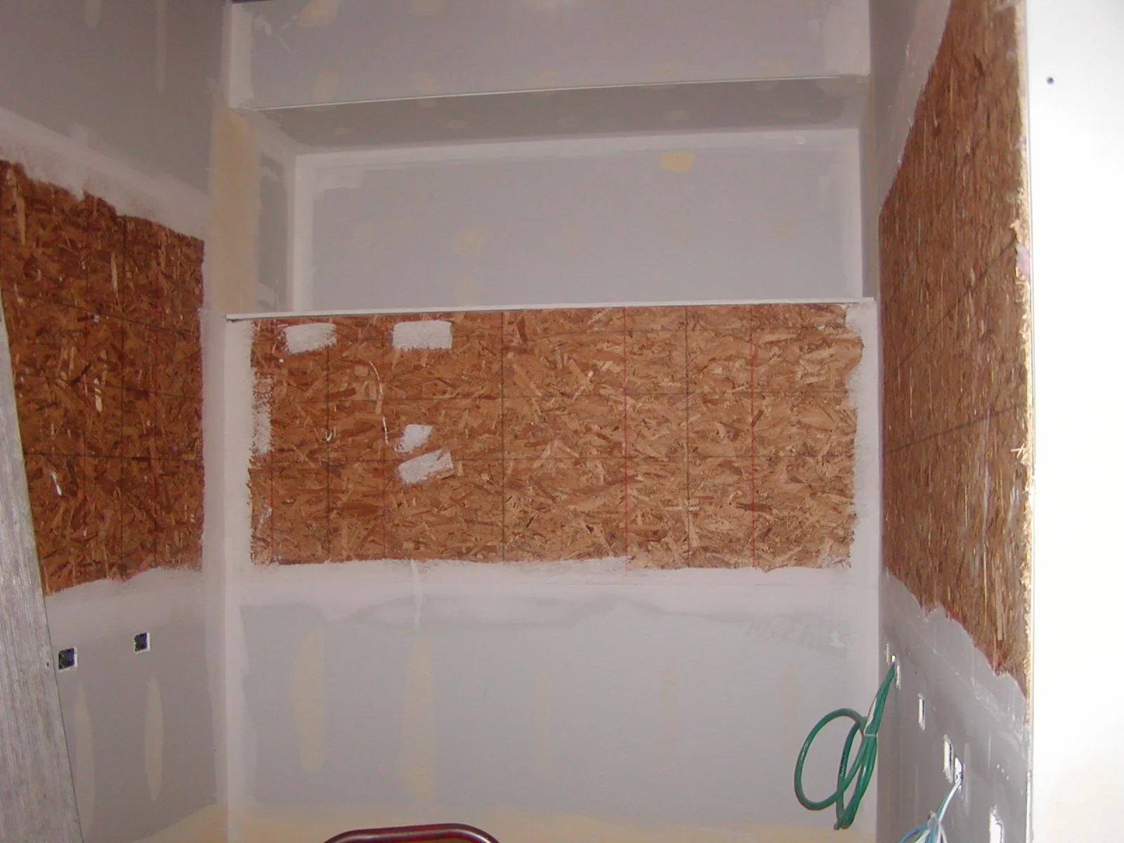 Interior view of a room with unfinished walls and exposed wood paneling