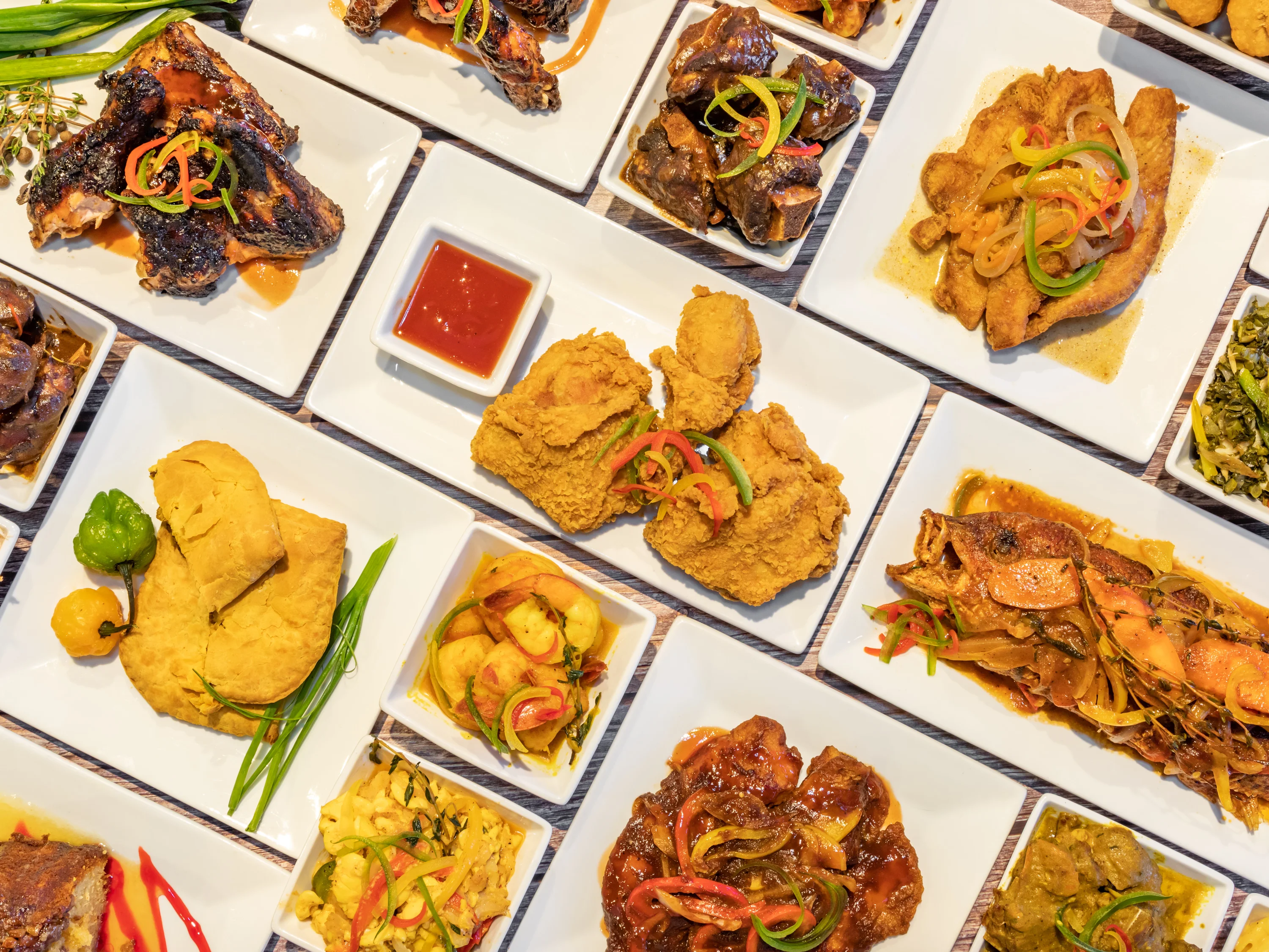 Assorted Caribbean dishes including fried chicken and fish