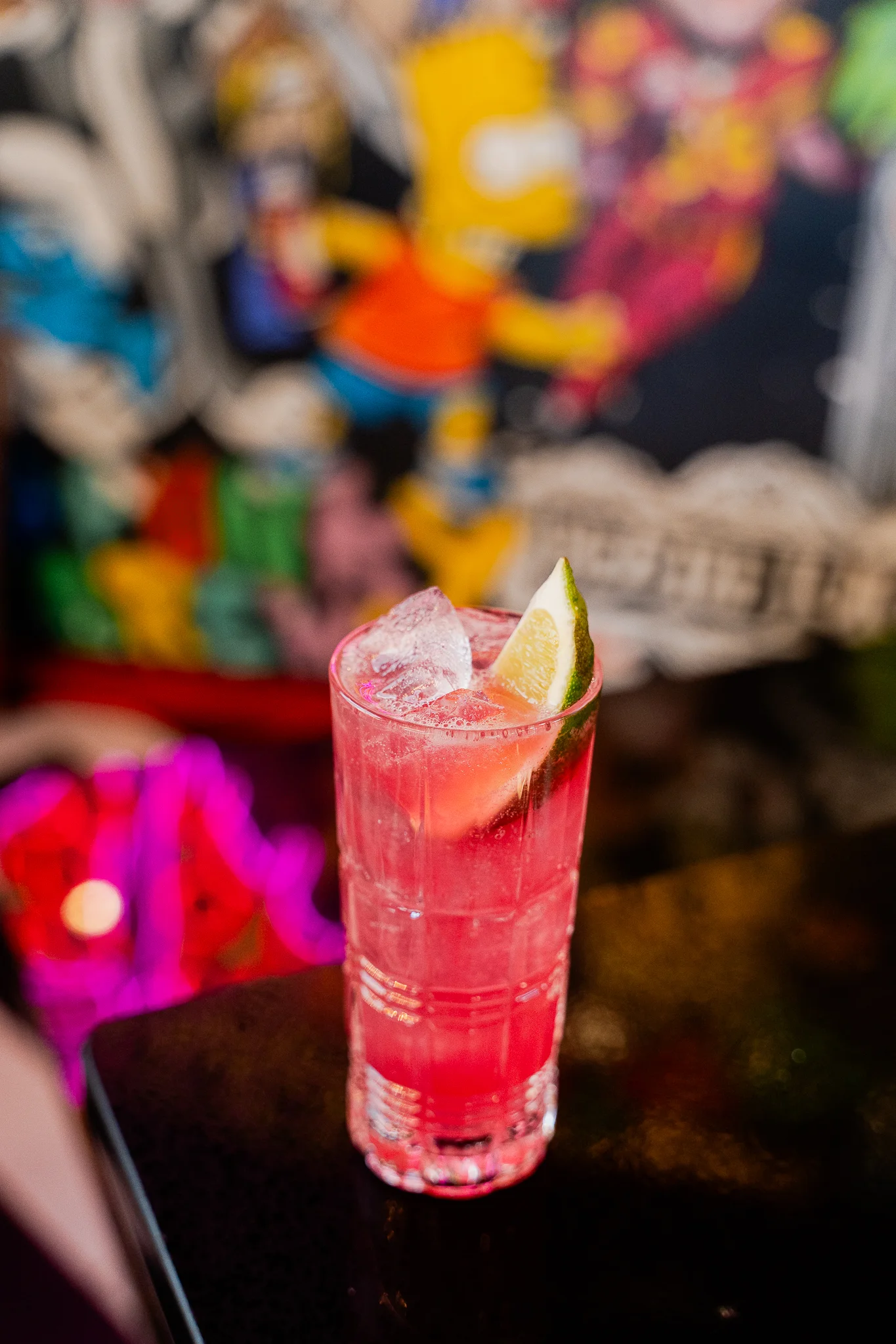 Colorful cocktails served in elegant glasses on a bar counter.
