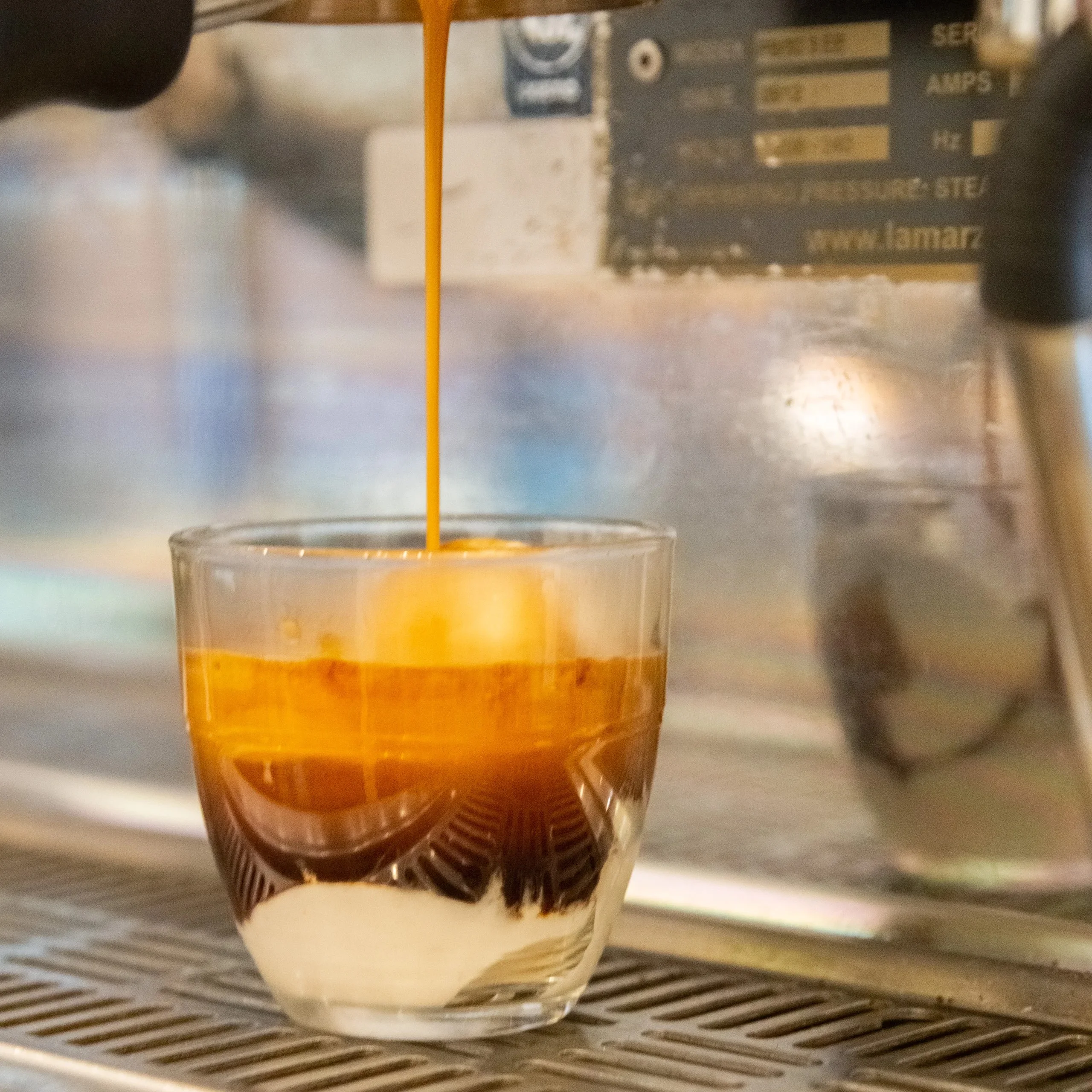 Espresso shot pouring over gelato in a glass