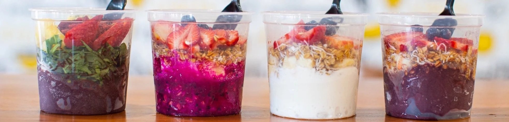 Colorful acai bowls with fresh fruits and granola