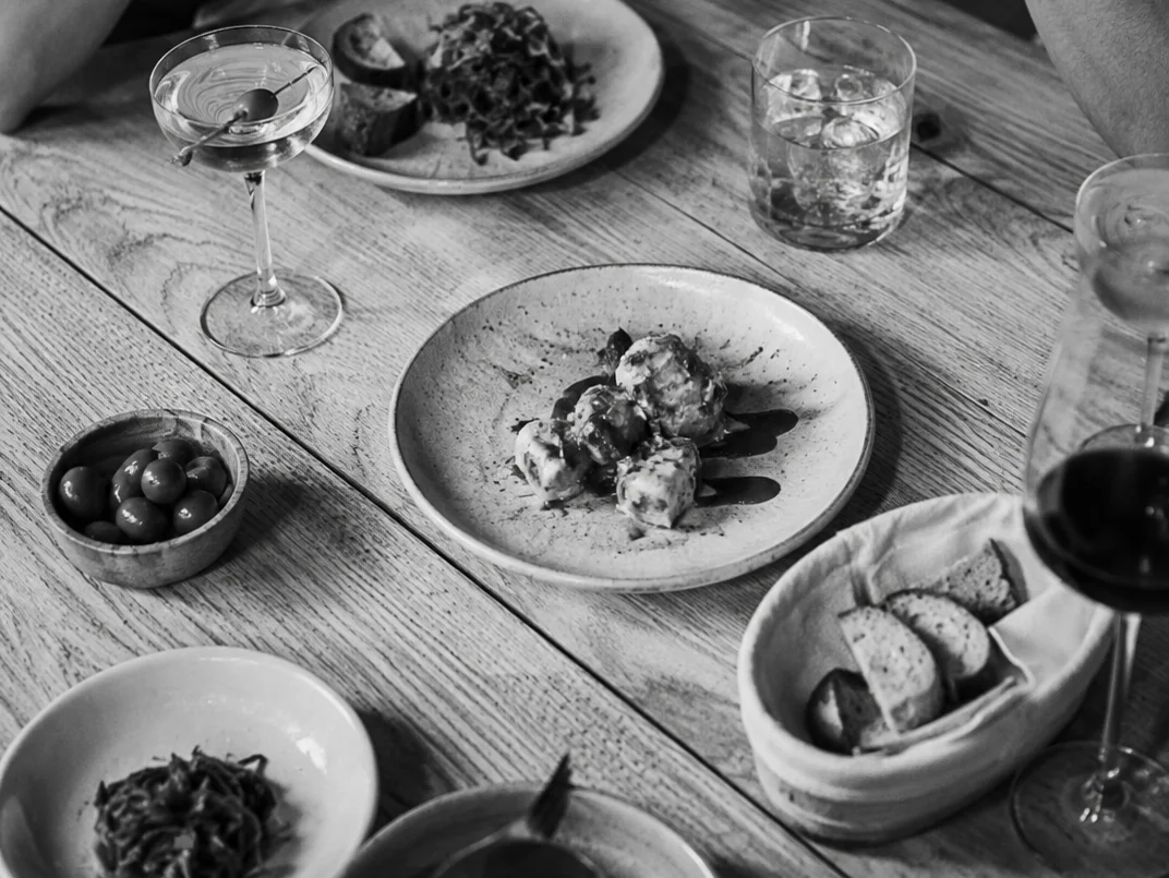 Elegant dining table with Italian antipasti and cocktails