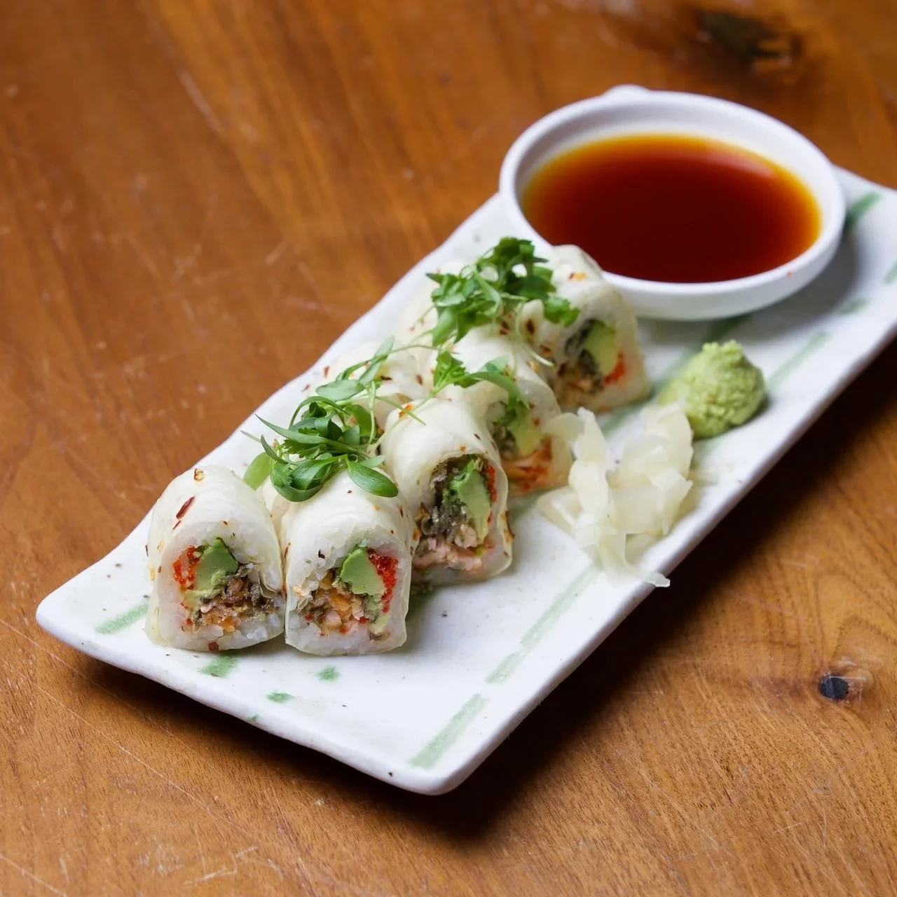 Japanese sushi rolls with fresh ingredients and dipping sauce