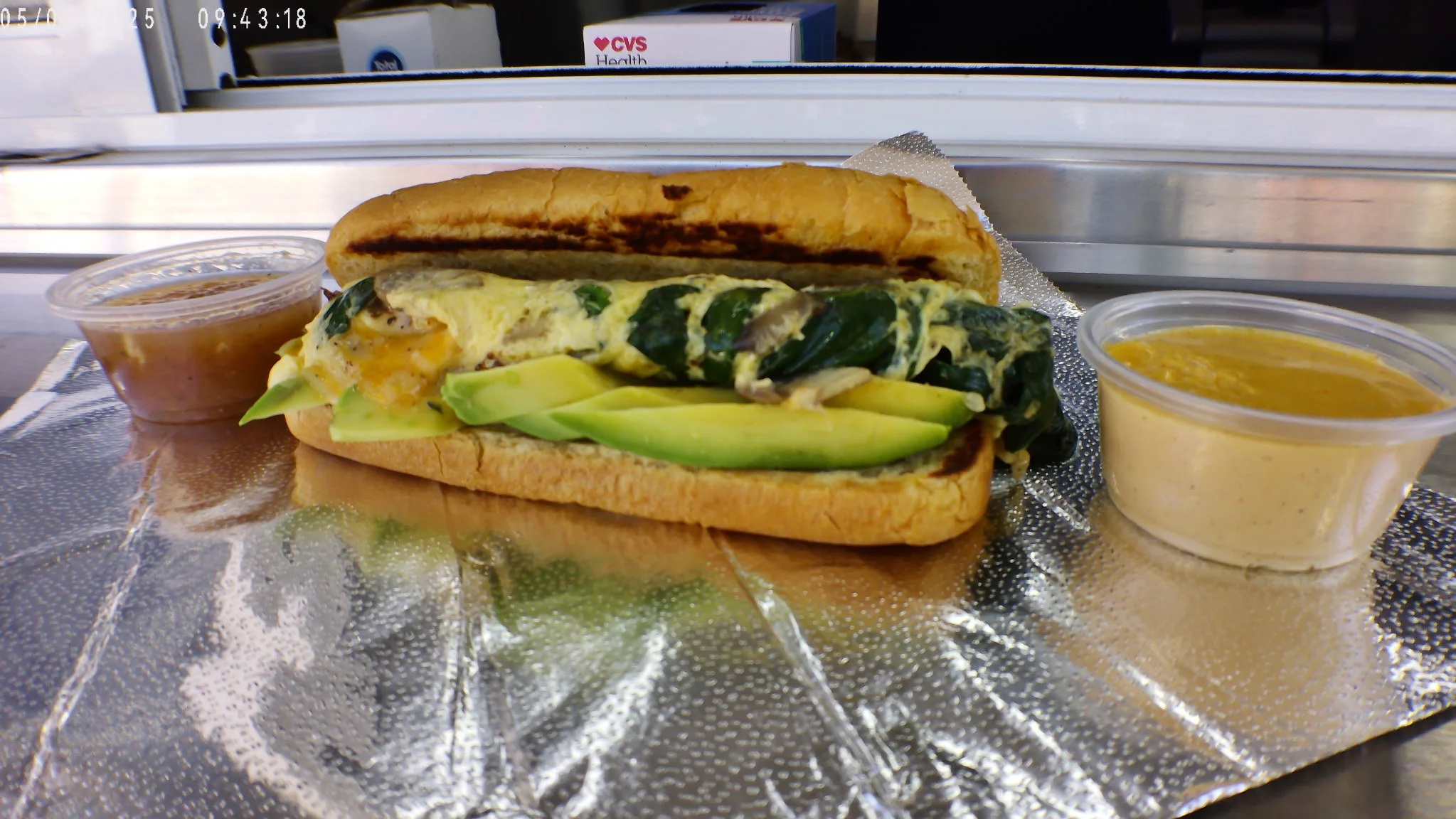 Mexican torta with egg, avocado, and salsa on the side